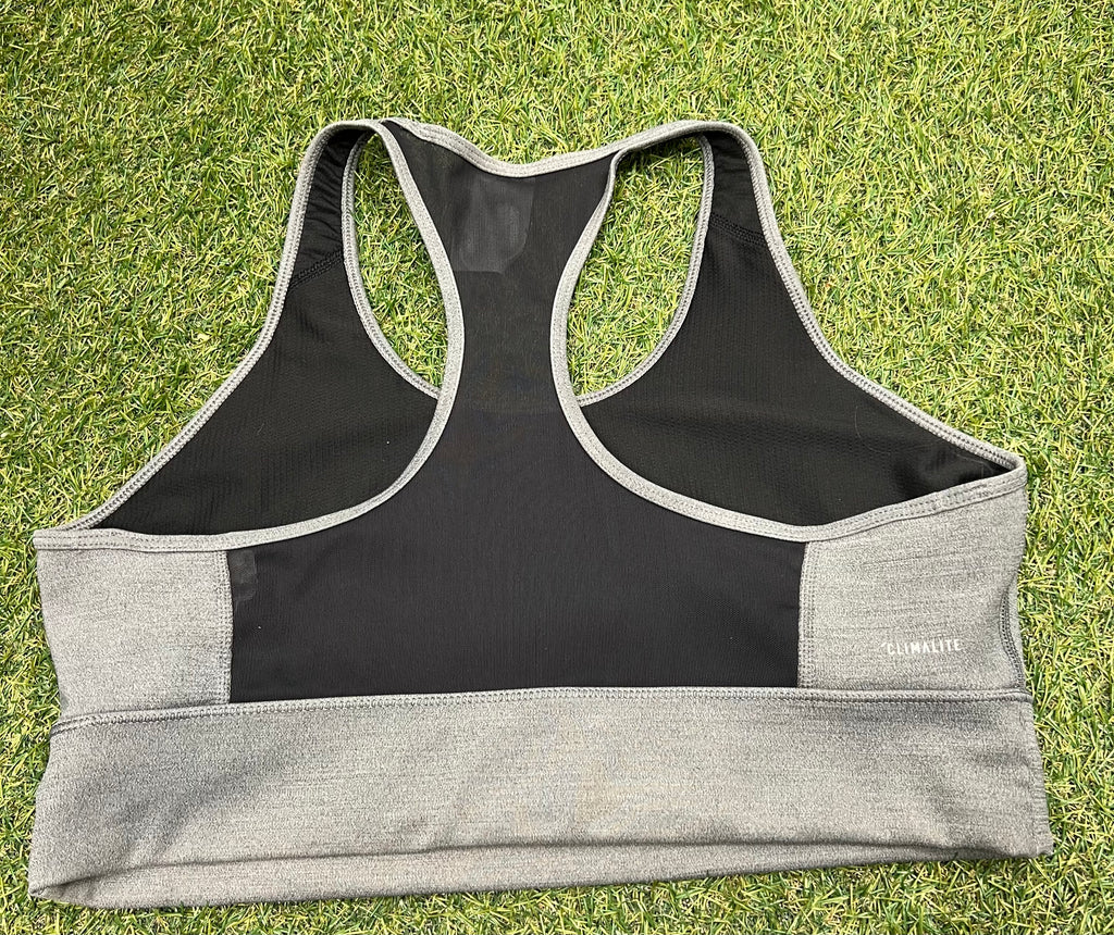 Back view of Adidas sports bra top showing black mesh racerback detail