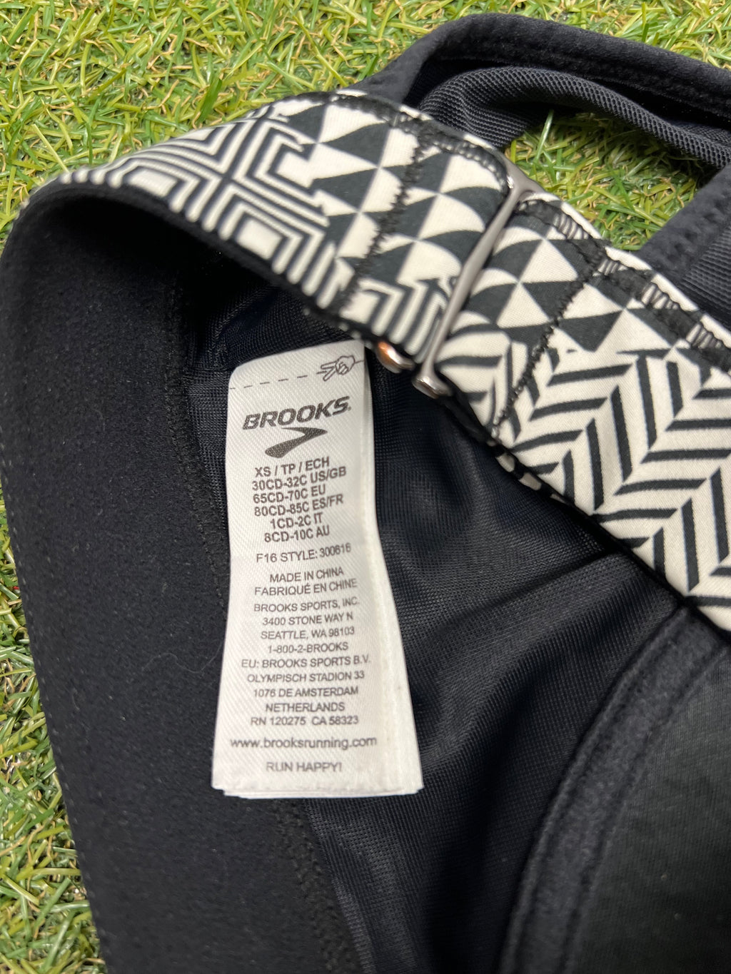Close-up of Brooks sports bra tag inside showing size XS and care details