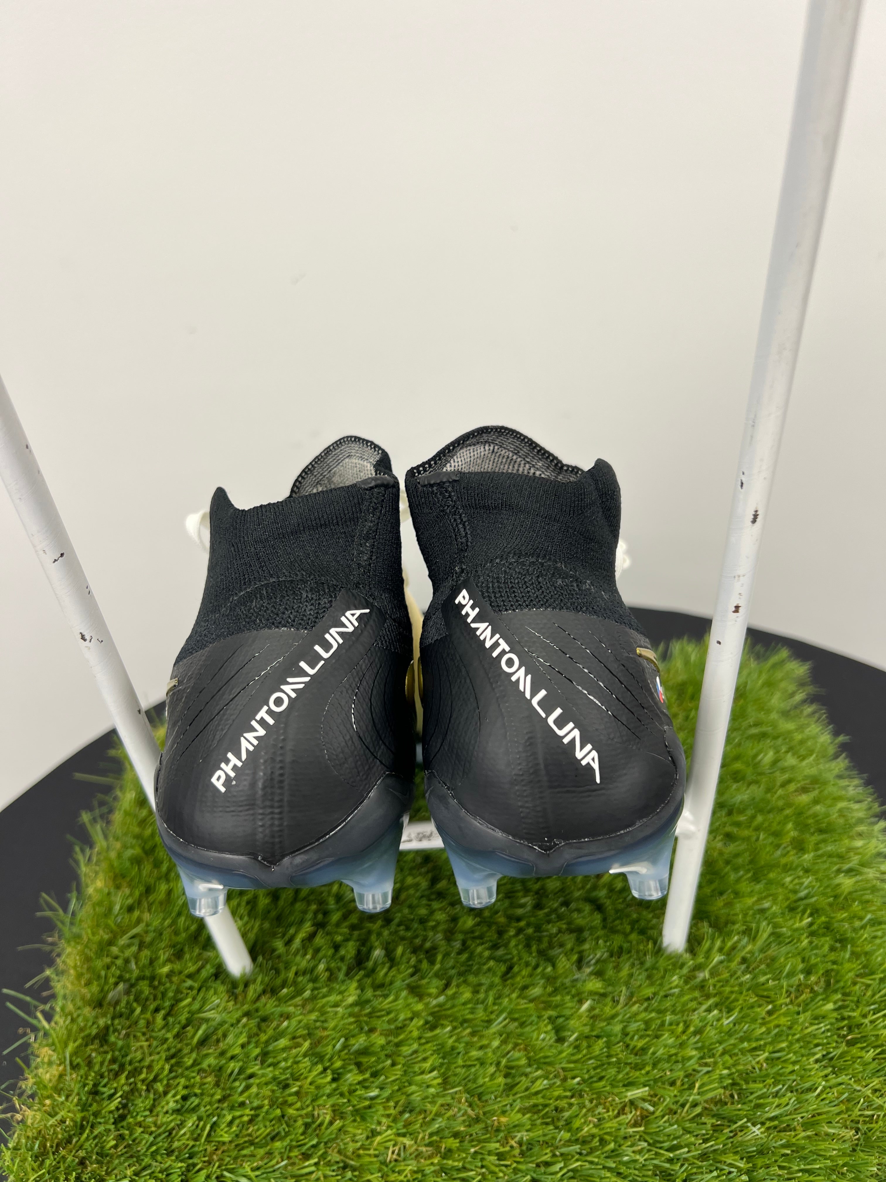 Back view of Nike Phantom Luna boots with black ankle cuffs and white branding
