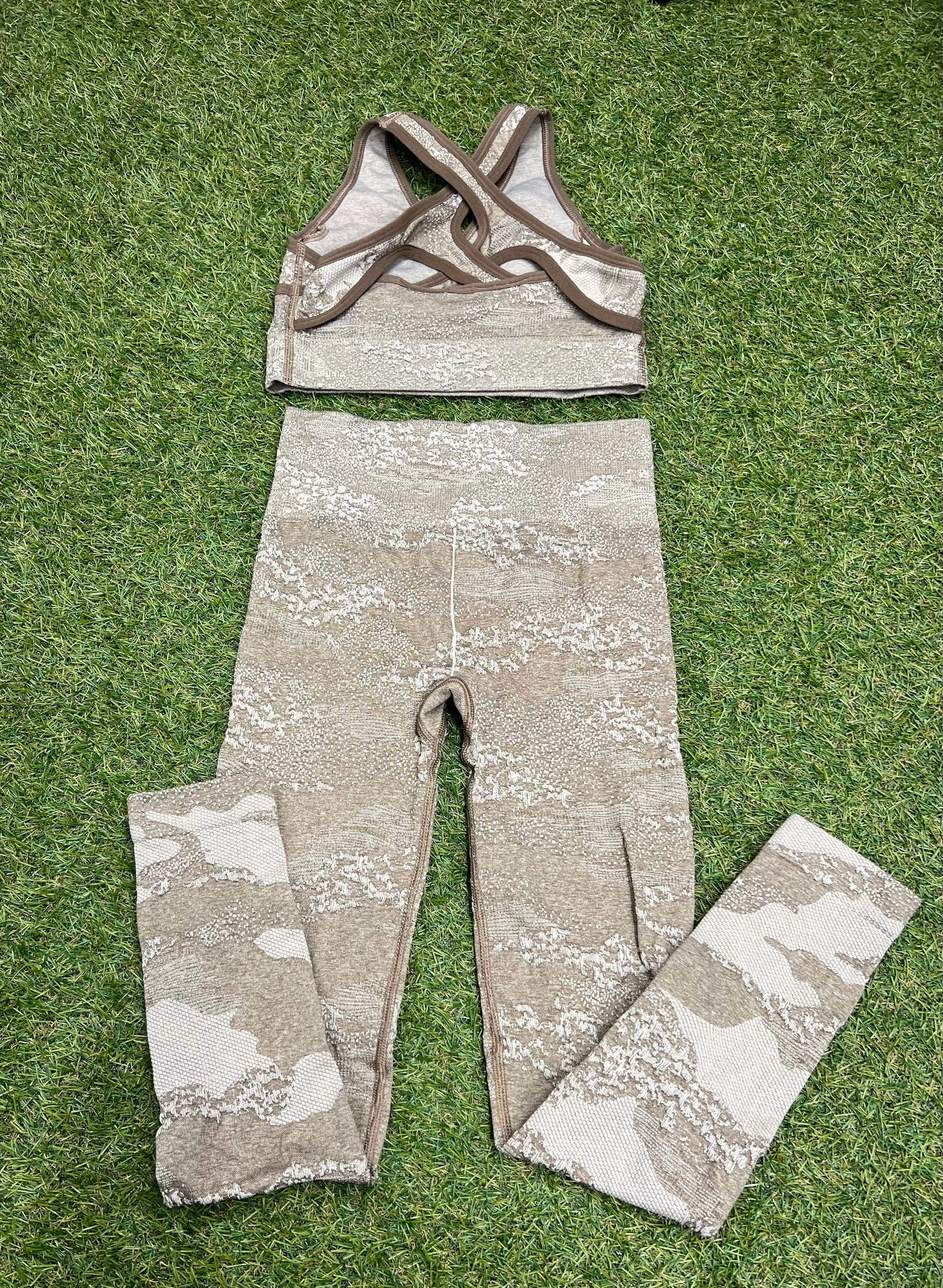 Back view showing cross-back straps of Gymshark sports bra and full-length leggings in camouflage print