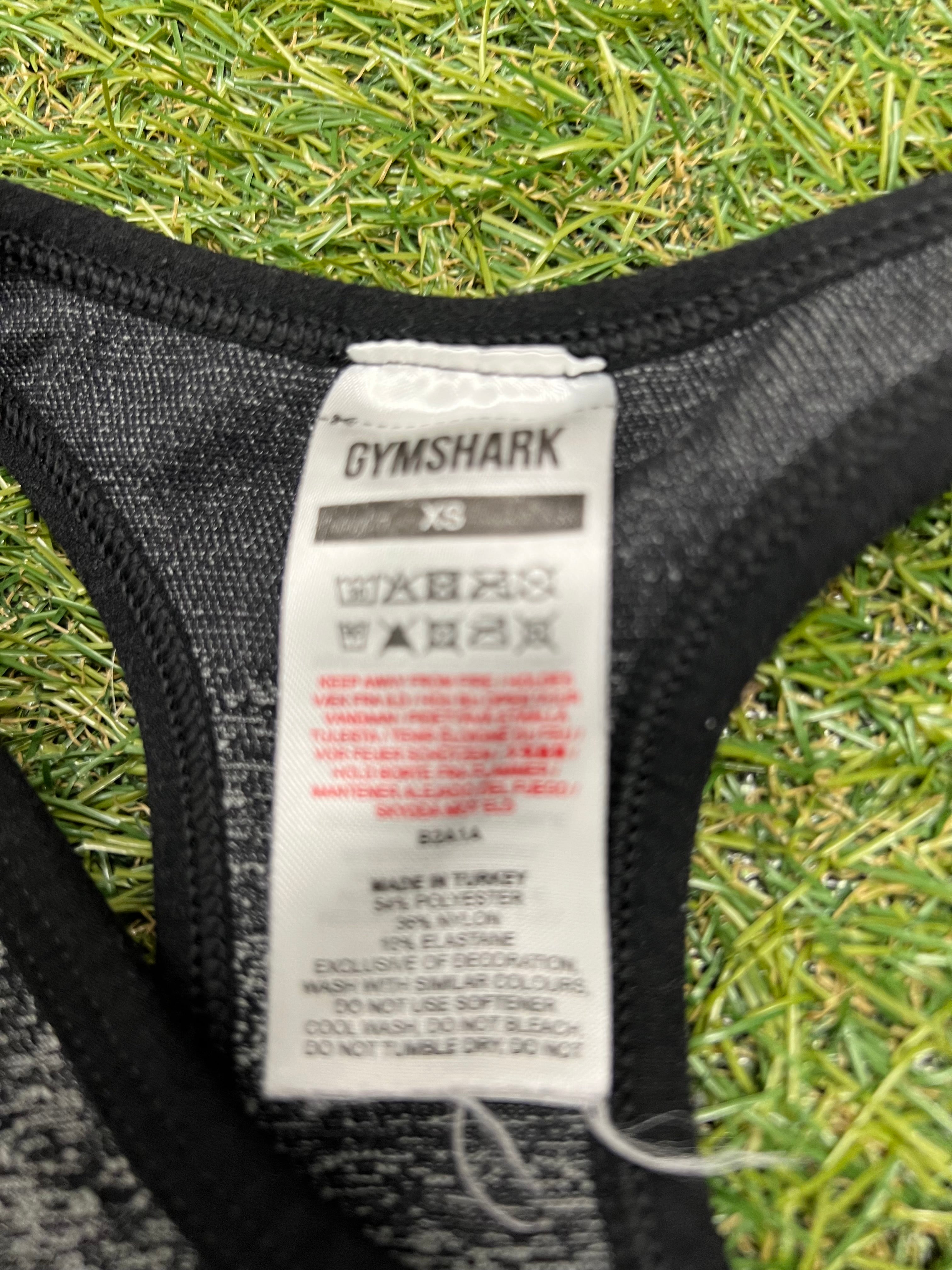 Close-up of Gymshark sports bra care and material tag showing fabric composition and washing instructions