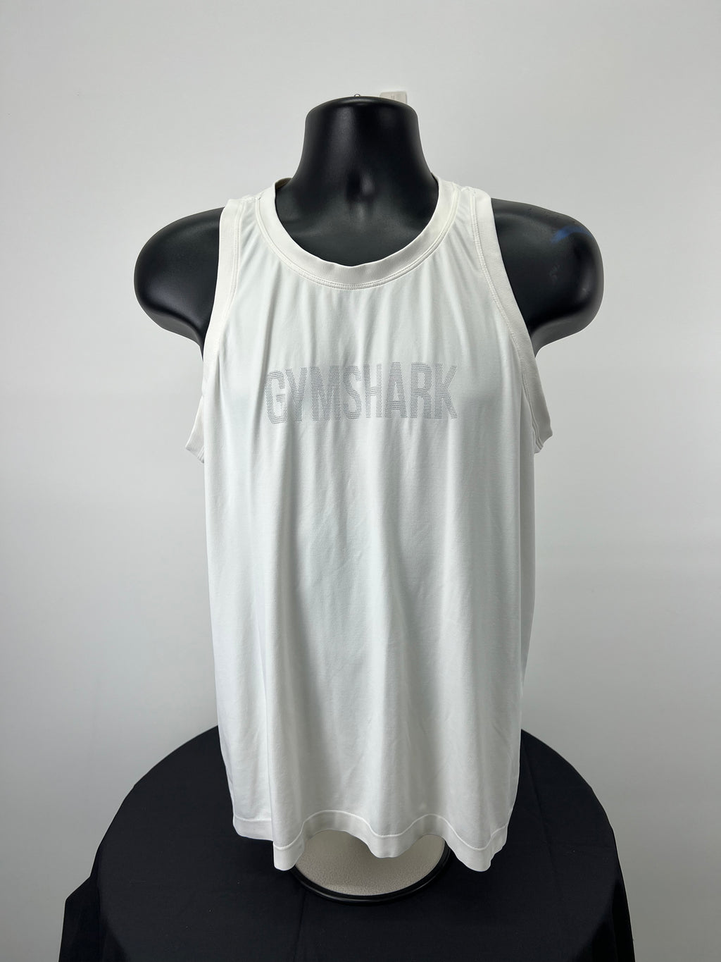 Front view of Gymshark white loose fitting vest top XL on black mannequin