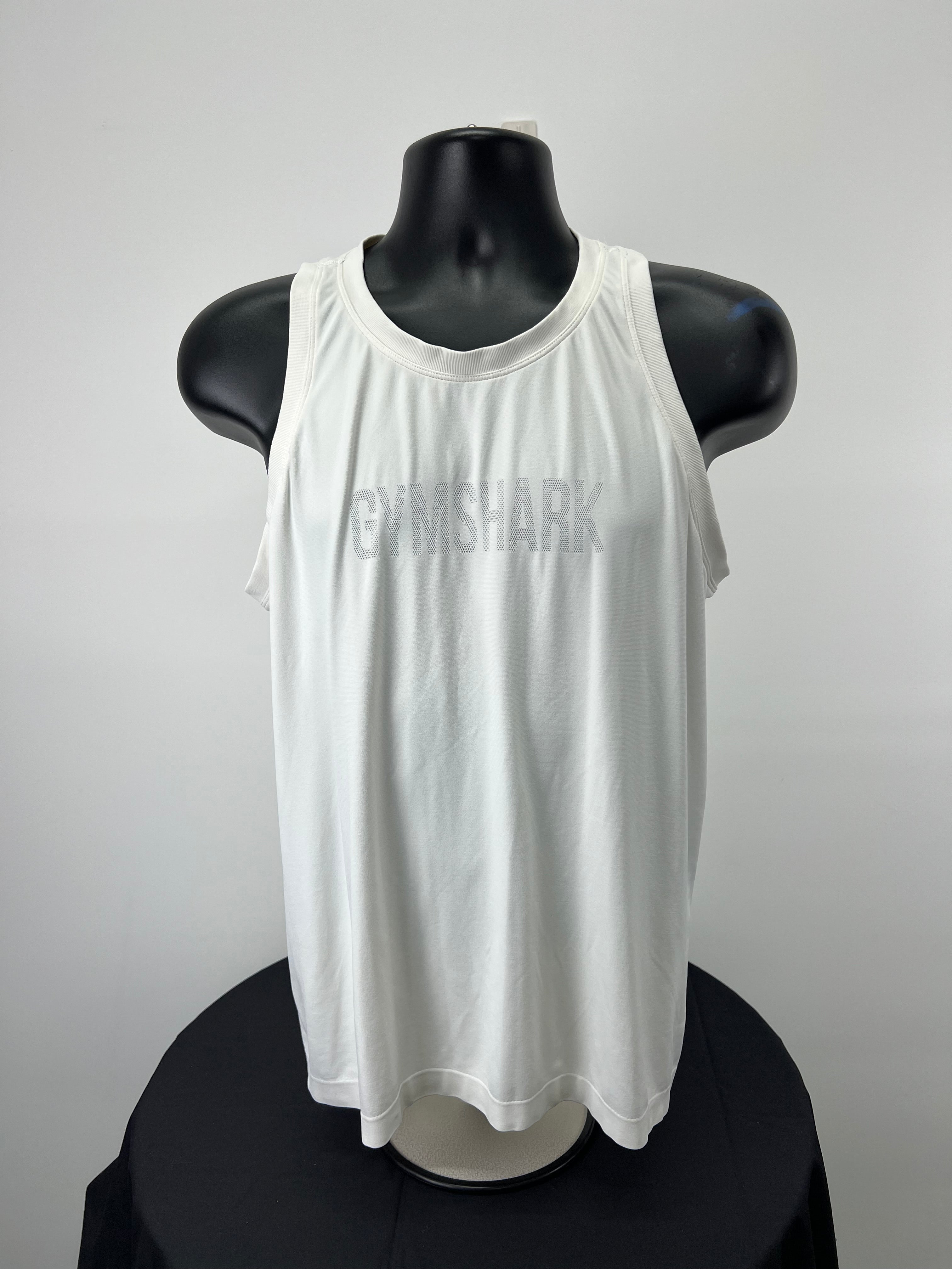 Front view of Gymshark white loose fitting vest top XL on black mannequin