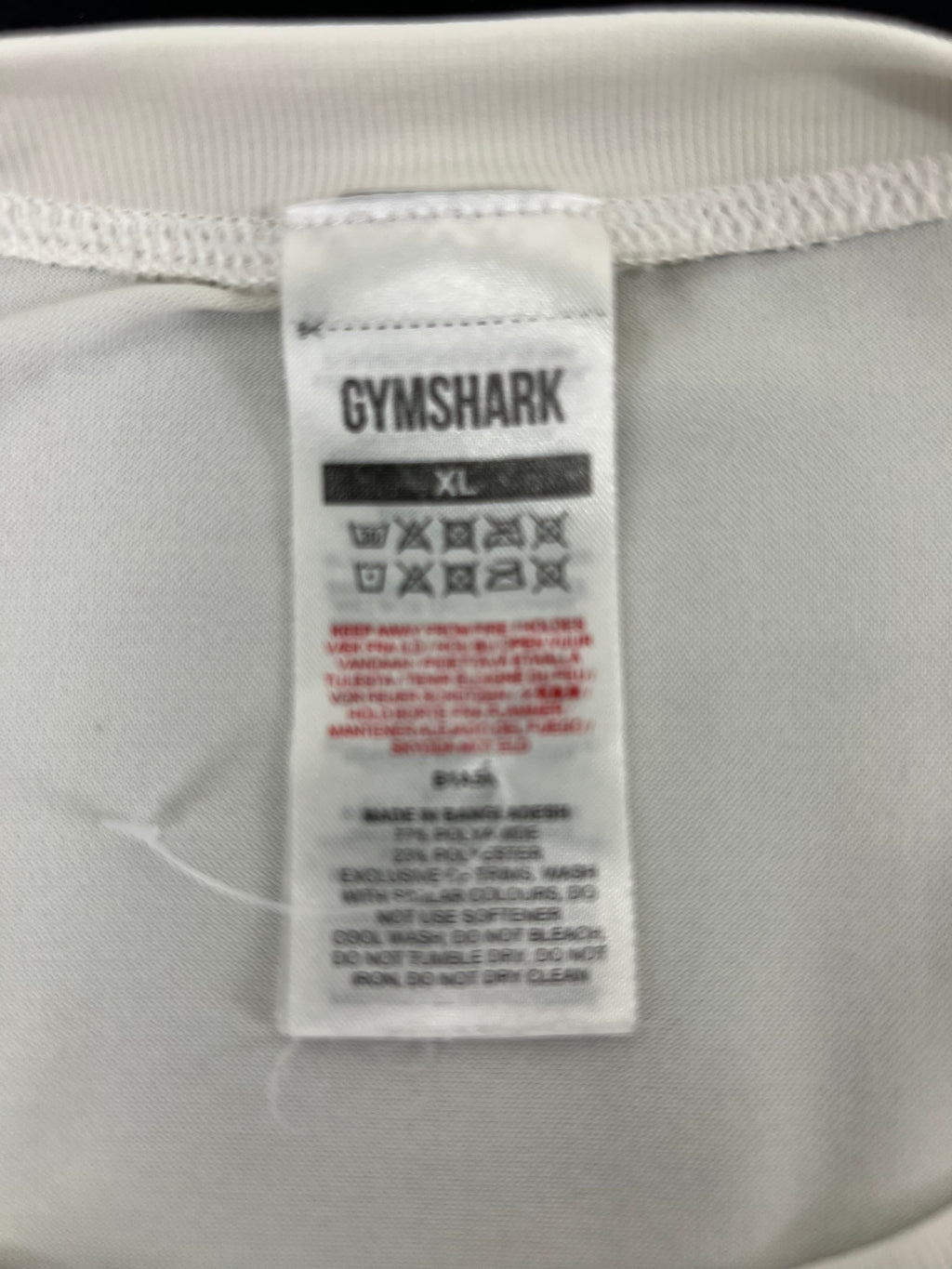 Close-up of Gymshark vest top care and fabric label showing size XL and fabric composition