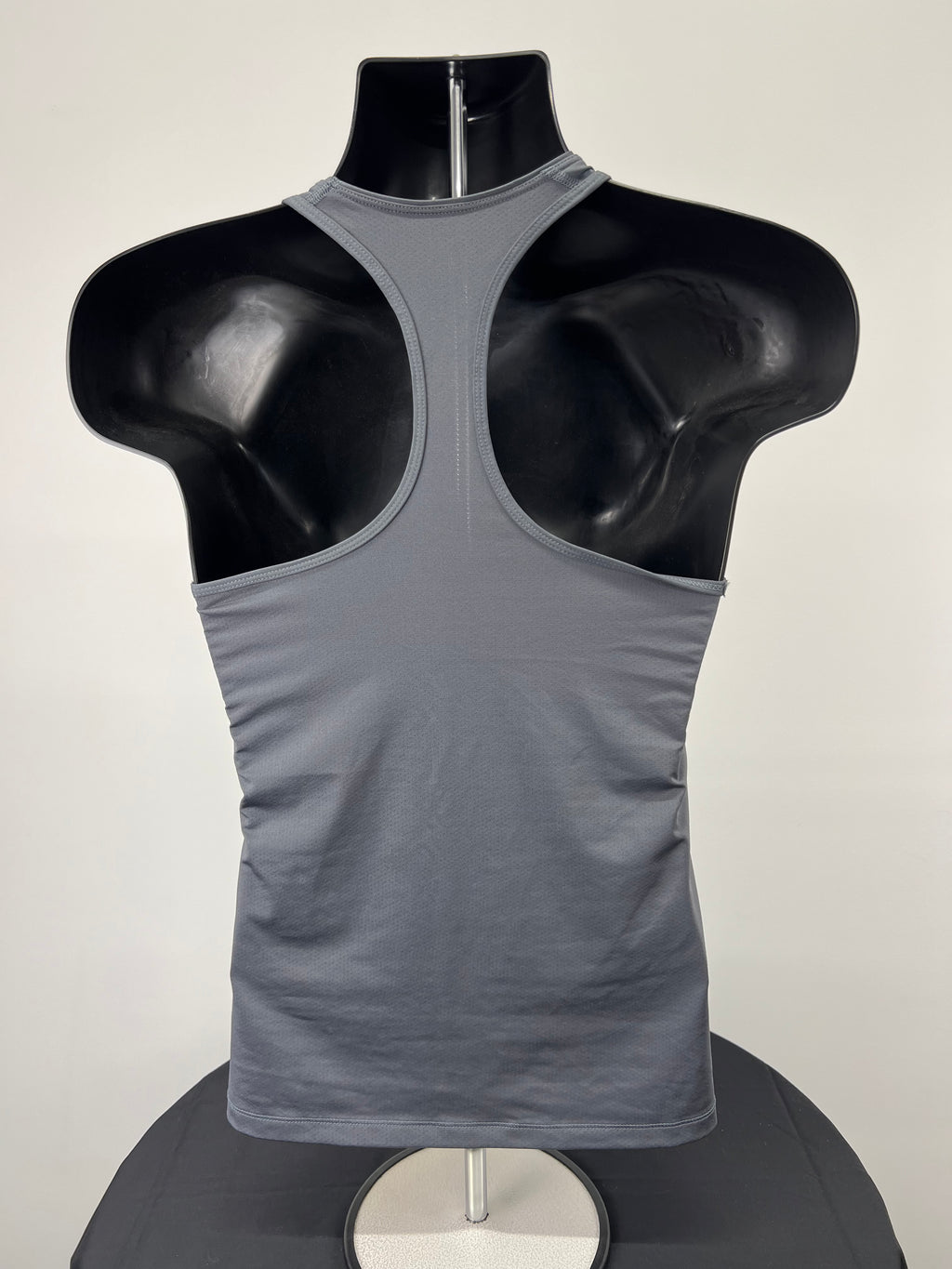 Back view of Nike Dri-Fit grey racerback sports vest on mannequin highlighting racerback design