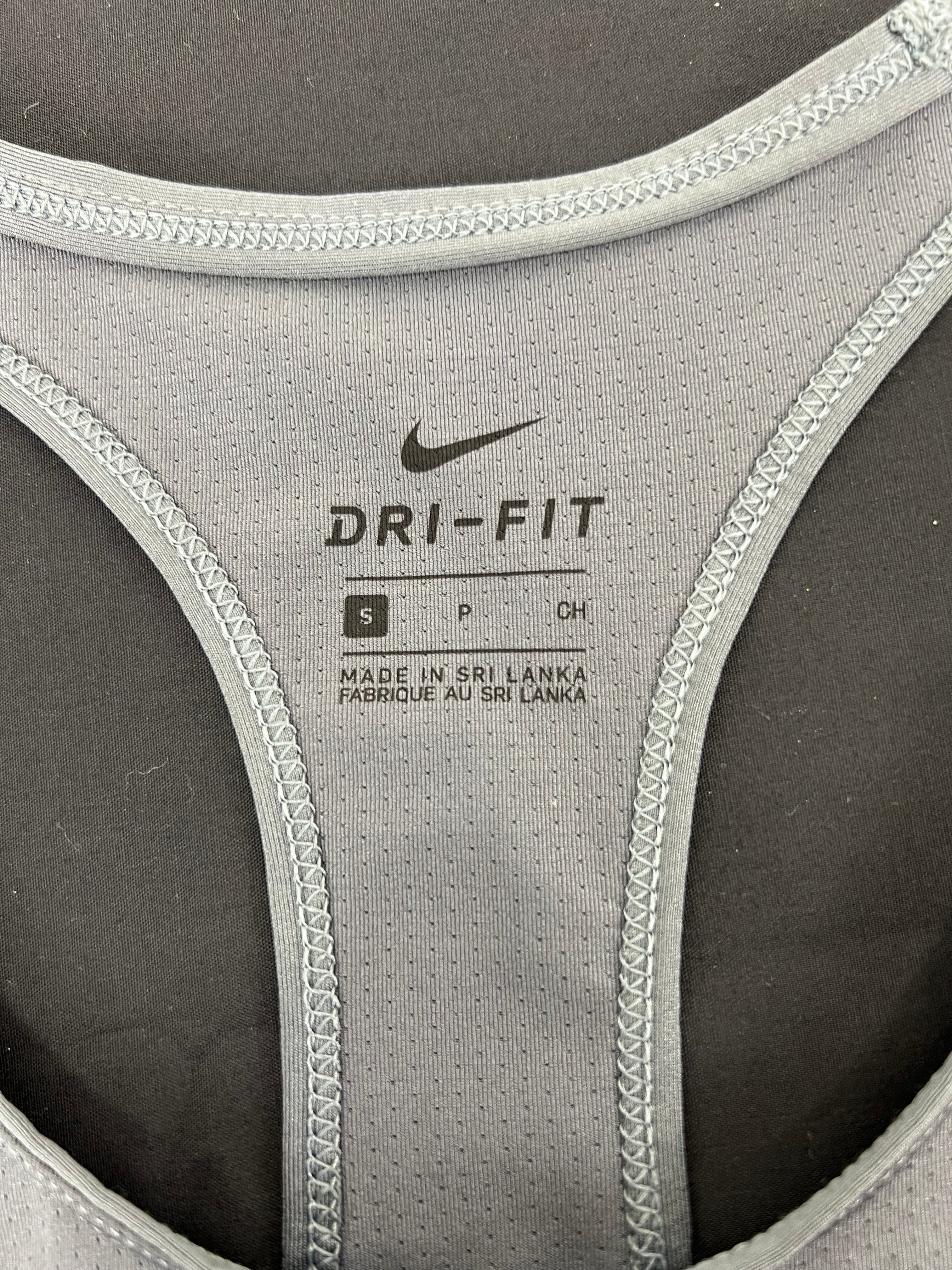 Close-up of Nike Dri-Fit label and stitching inside grey sports vest