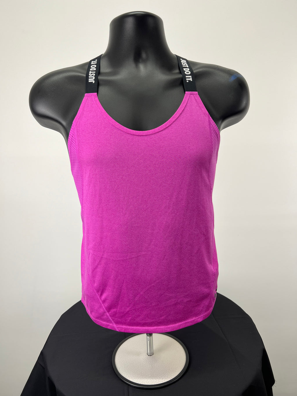 Front view of pink Nike sports vest with elastic 'Just Do It.' straps on a mannequin