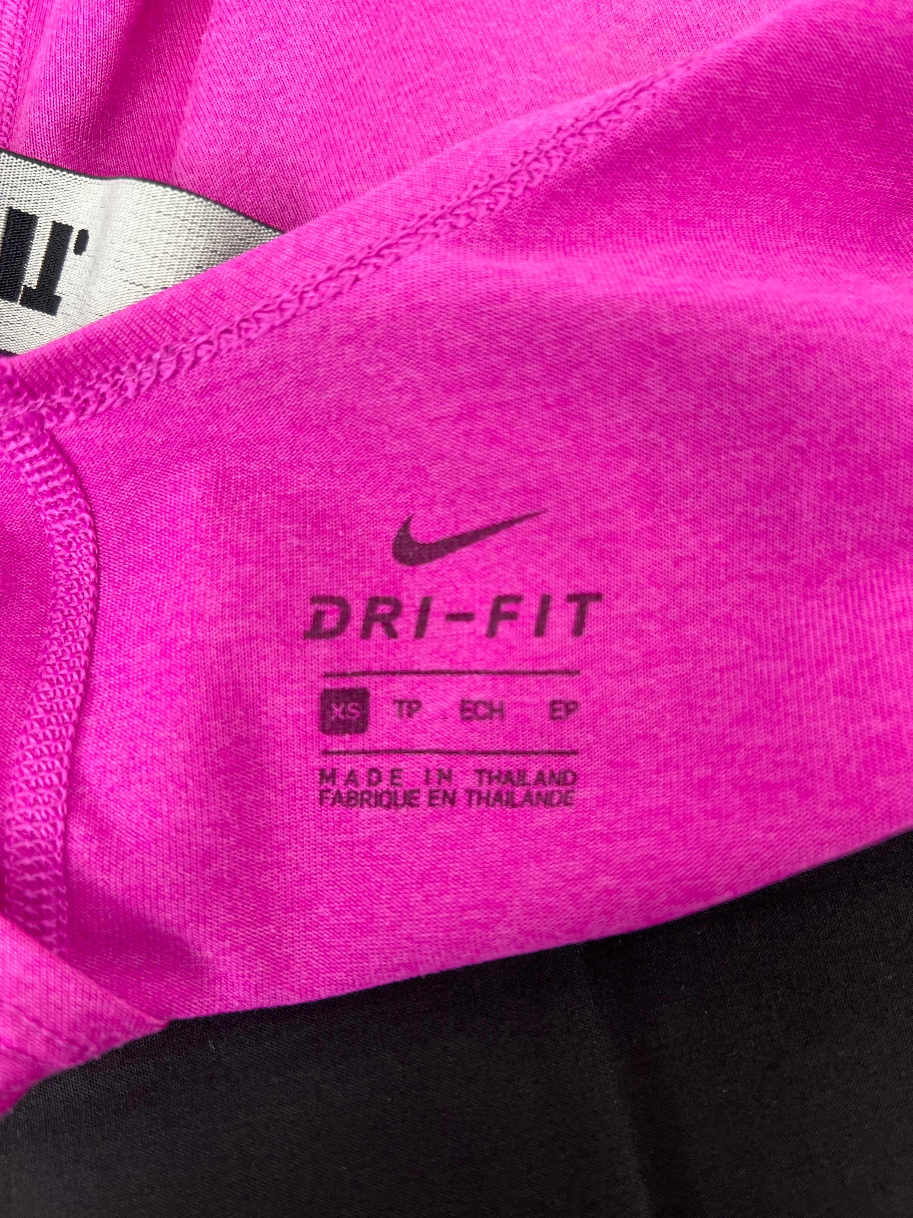 Close-up of Nike Dri-FIT label printed on pink sports vest fabric