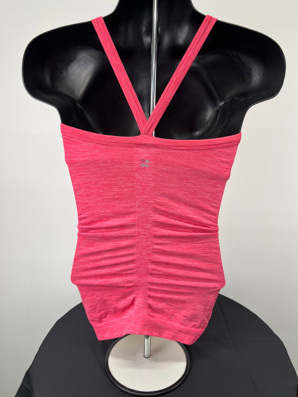 Back view of pink Sweaty Betty elasticated vest top showing thin straps