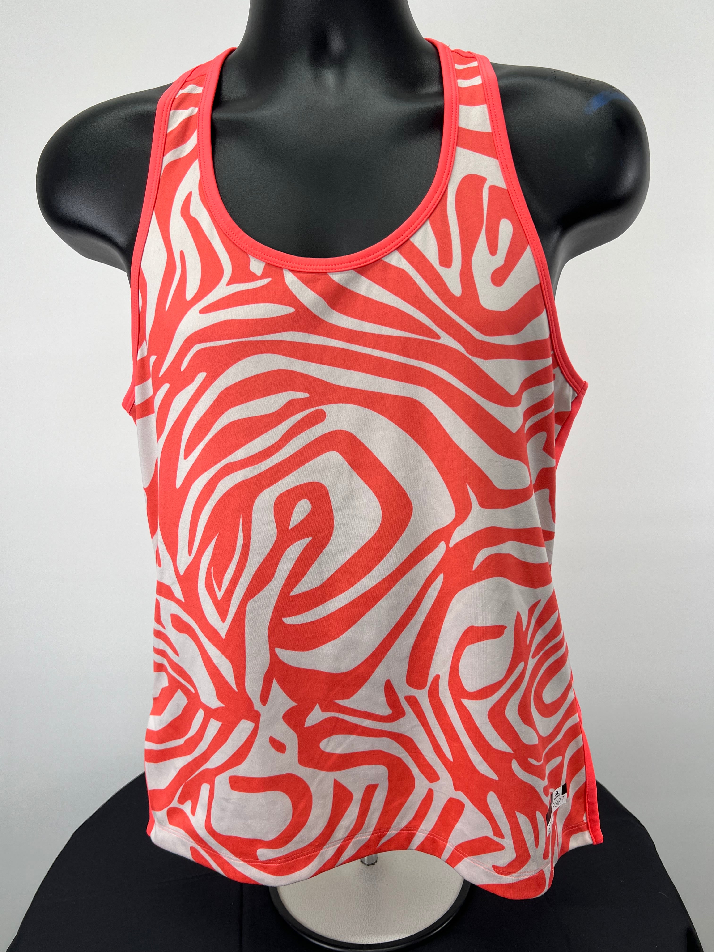 Front view of adidas Stella McCartney orange and white printed sports vest on black mannequin
