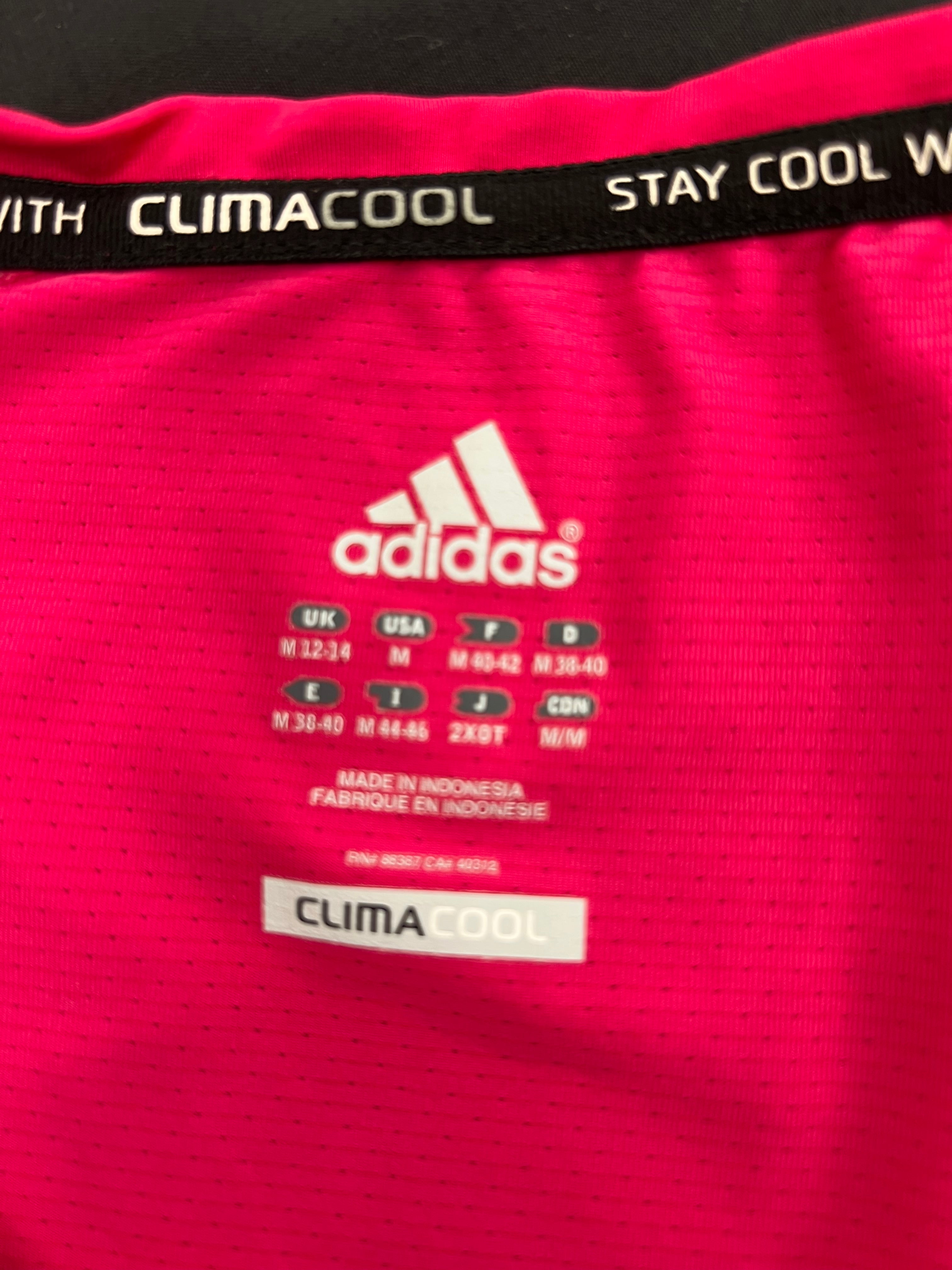 Close-up of adidas Climacool label and sizing information inside bright pink sports vest