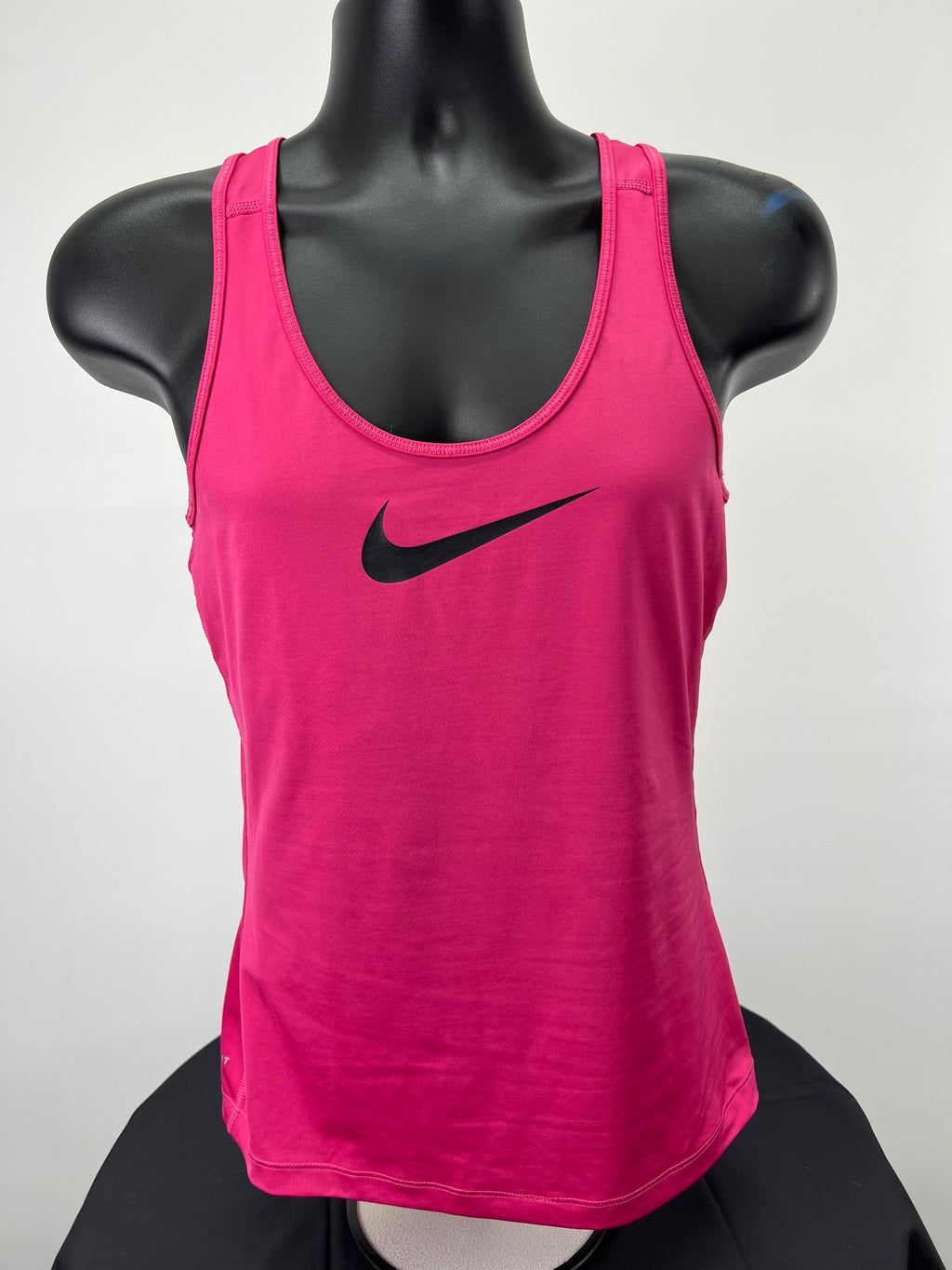 Front view of bright pink Nike Pro vest top with black Nike swoosh logo on mannequin