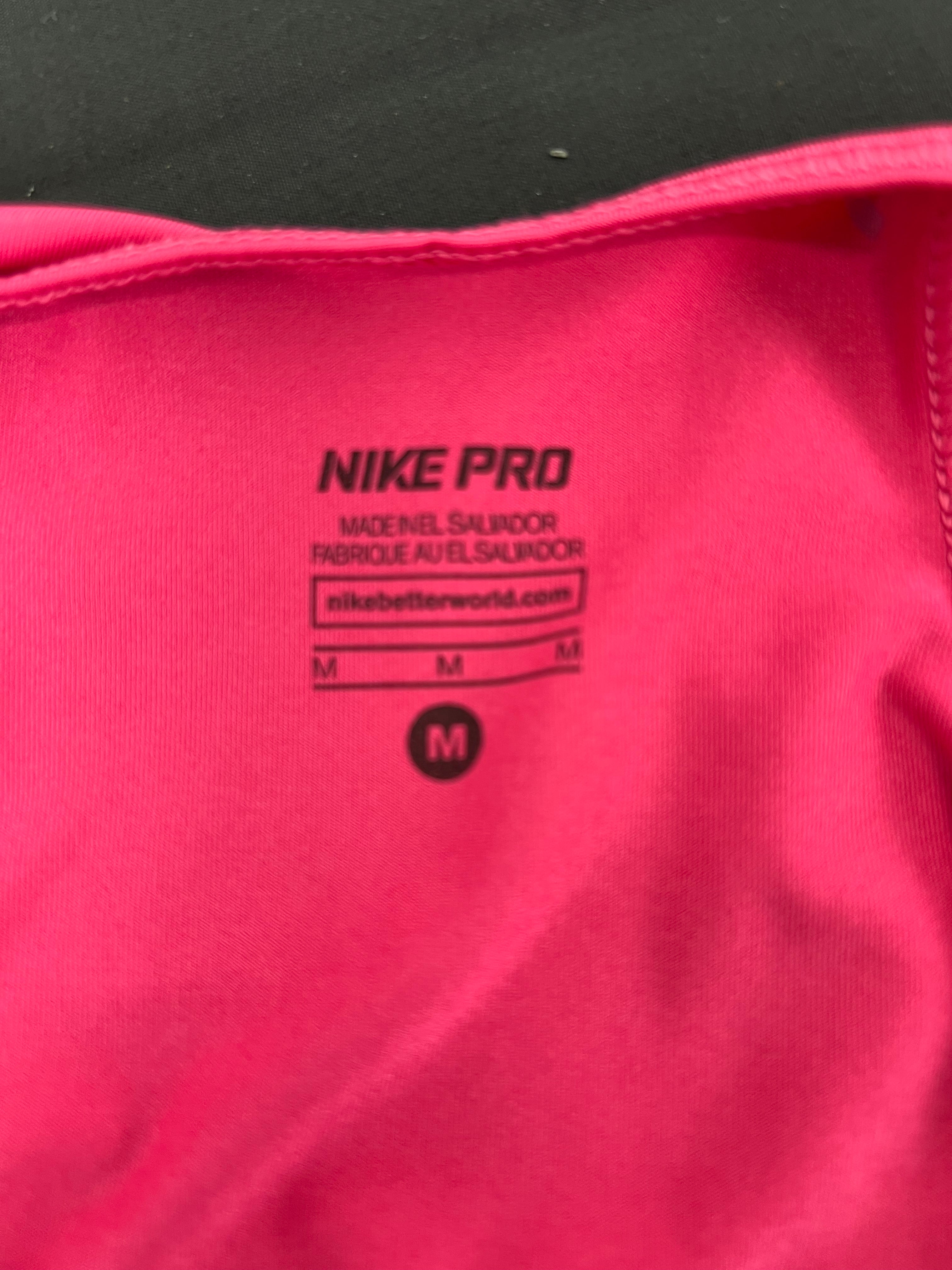 Close-up inside label of Nike Pro vest top showing size medium made in El Salvador