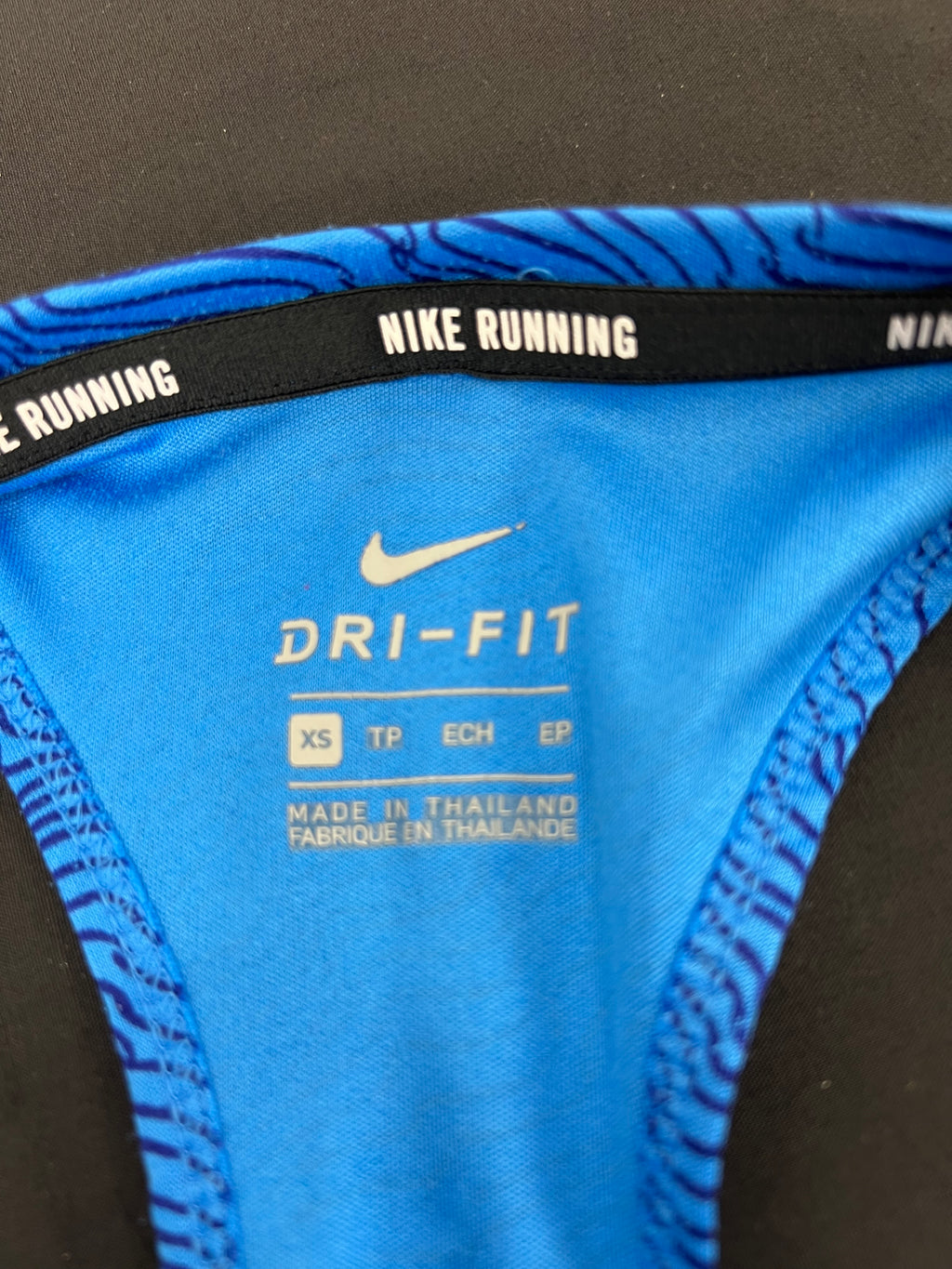 Close-up of inside label showing Nike Dri-Fit technology and XS size