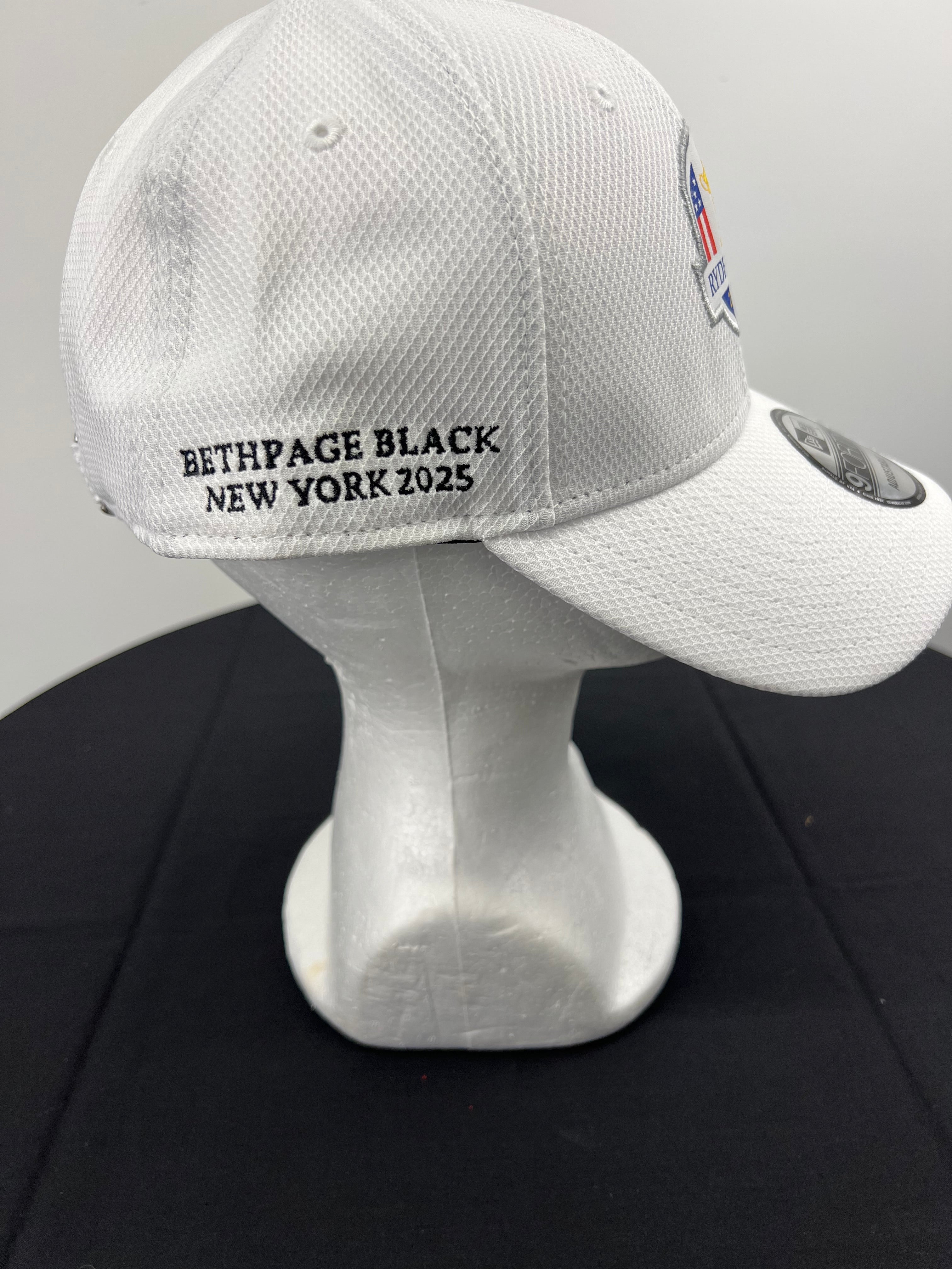Side view of white cap showing Bethpage Black New York 2025 embroidery
