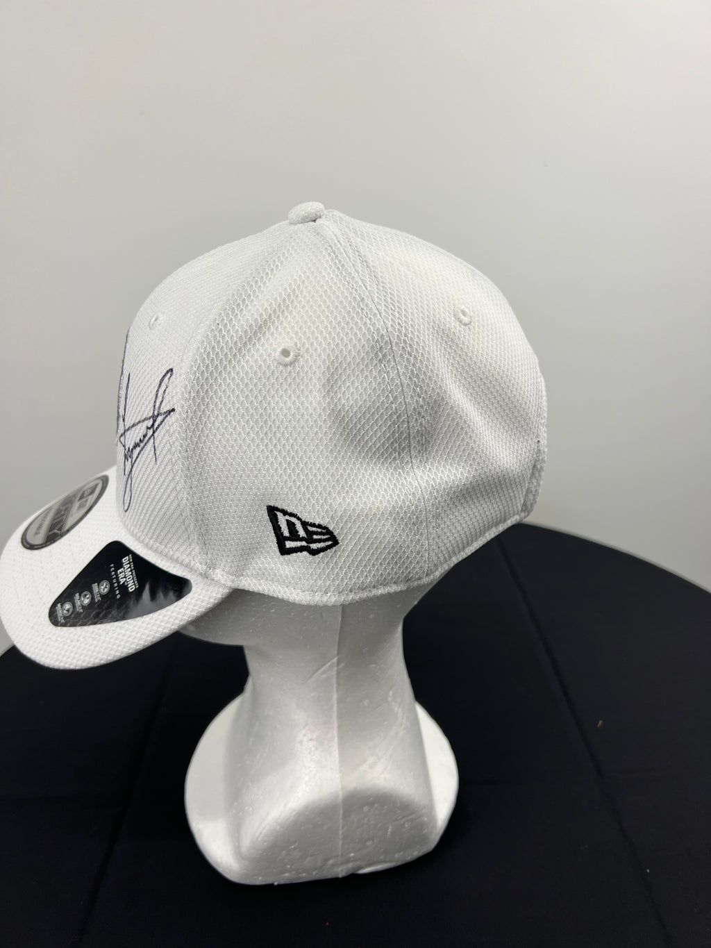 Close-up of Luke Donald's signature on the front panel of the white Ryder Cup cap