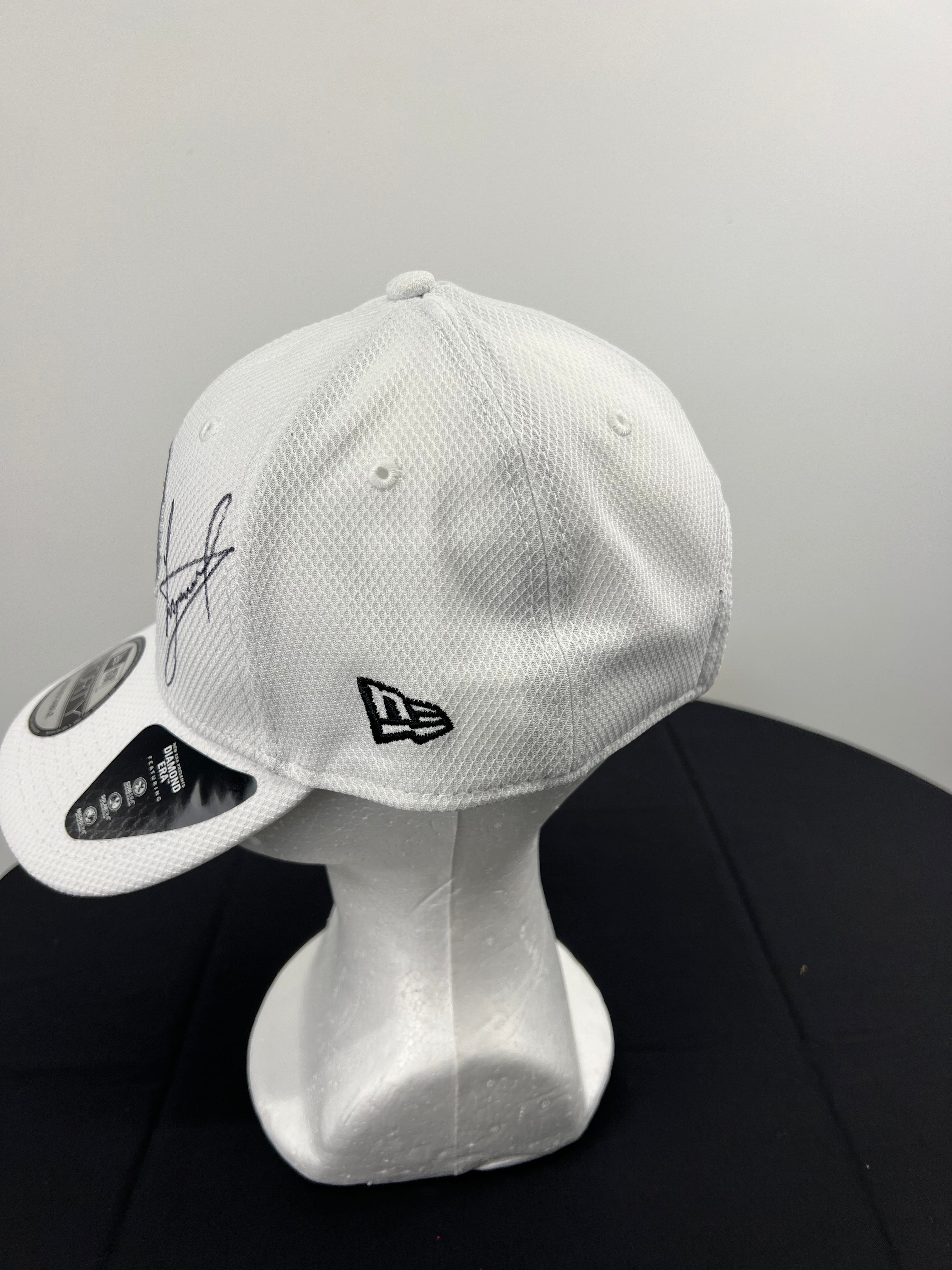 Close-up of Luke Donald's signature on the front panel of the white Ryder Cup cap