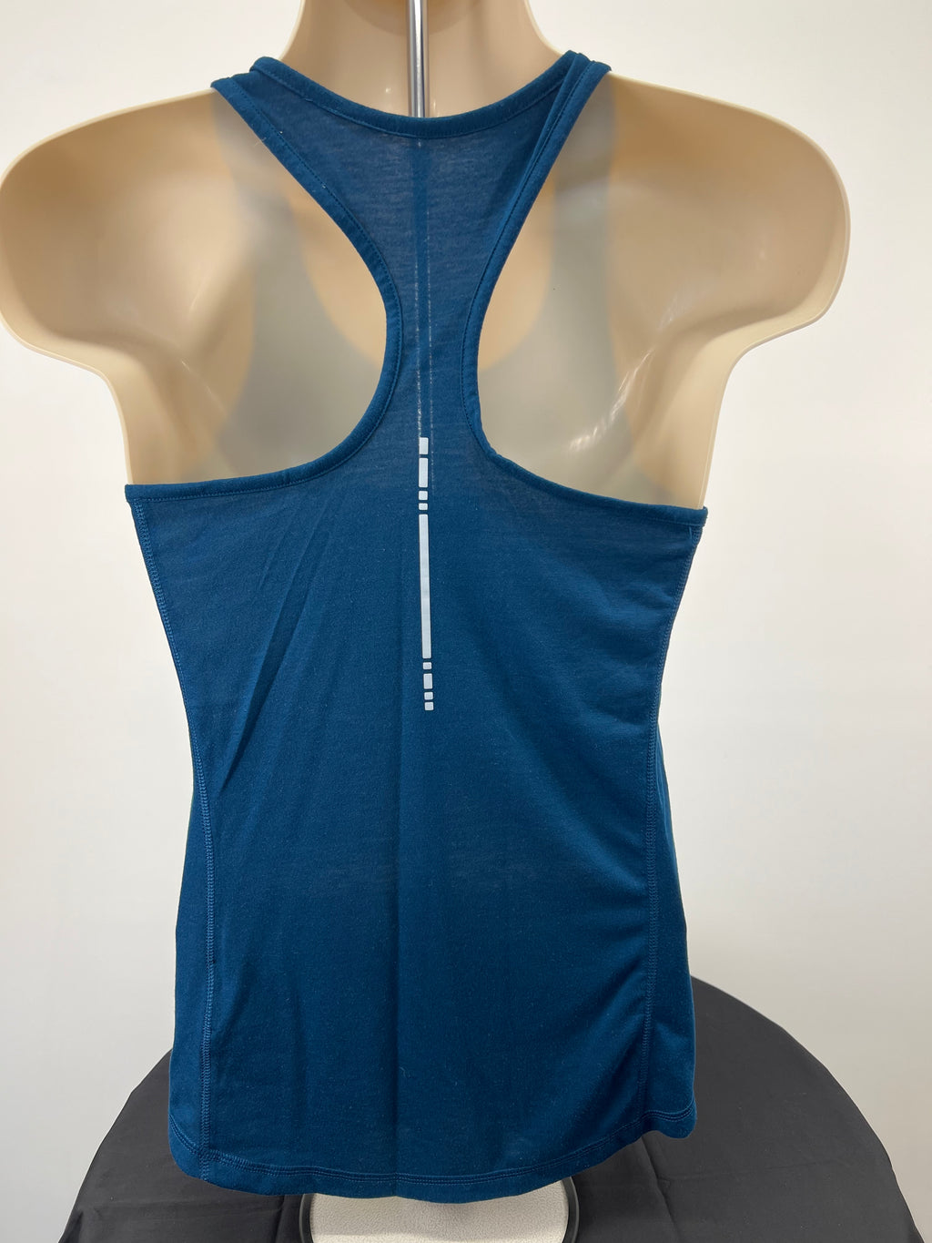 Back view of Asics blue running vest top on mannequin with racerback design and reflective strip