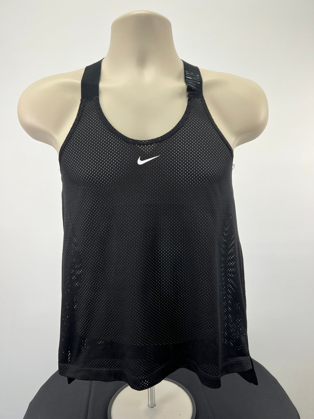 Nike black mesh vest top front view on mannequin showing white Nike swoosh logo