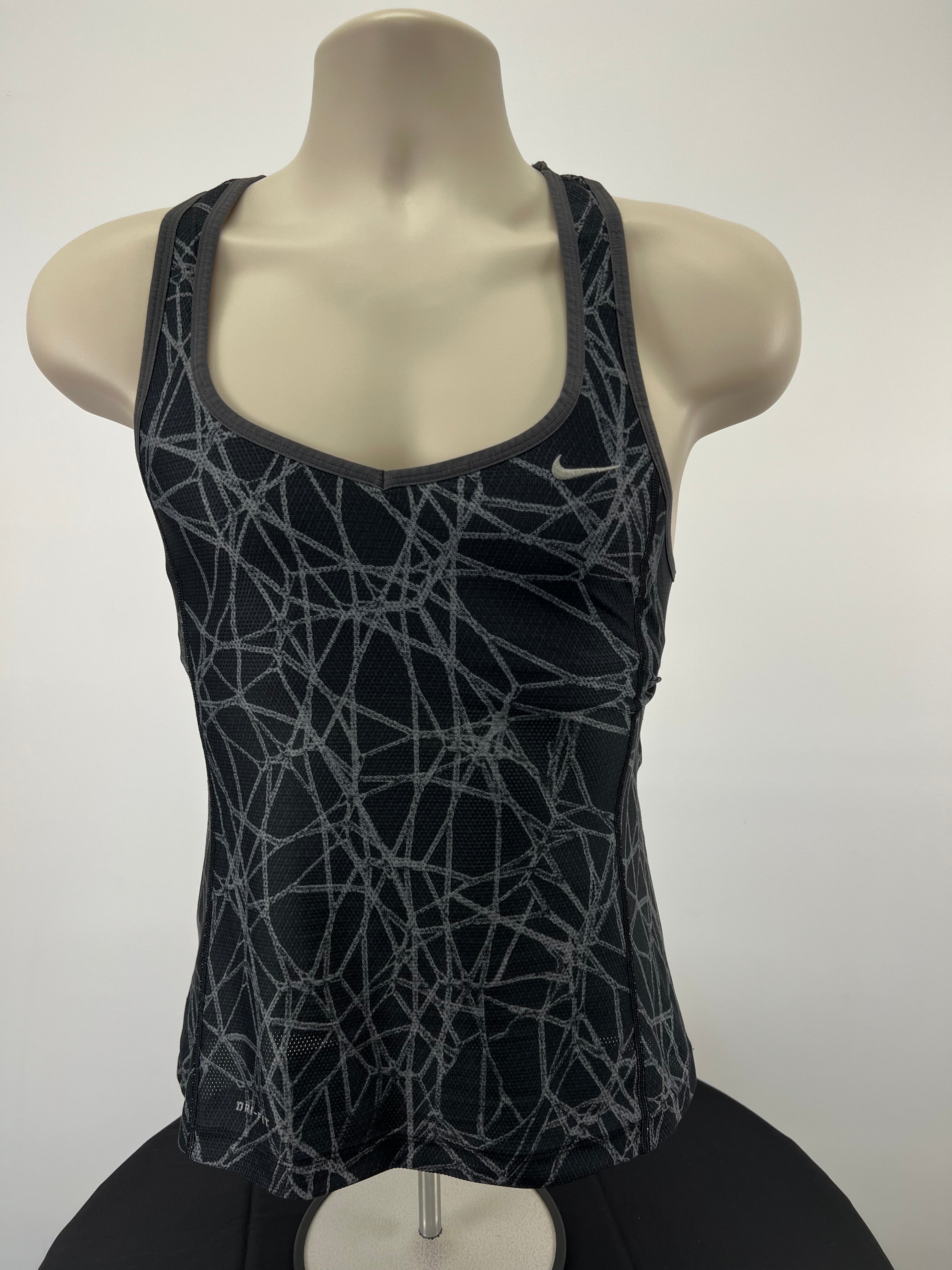 Front view of Nike grey patterned vest top with built-in bra on mannequin