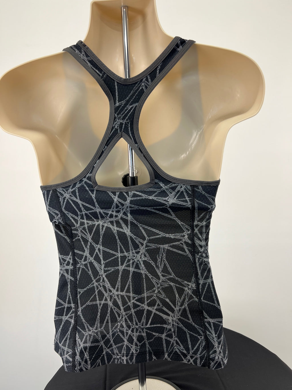 Back view of Nike vest top showing racerback design and abstract grey pattern