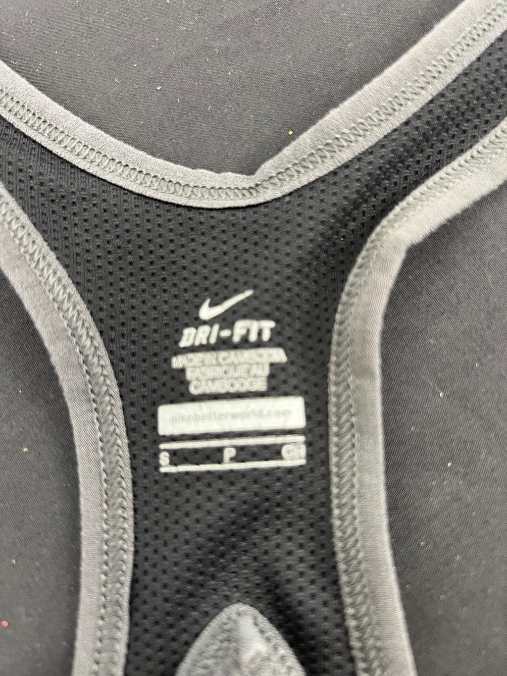 Close-up of Nike Dri-Fit fabric label inside grey patterned vest top