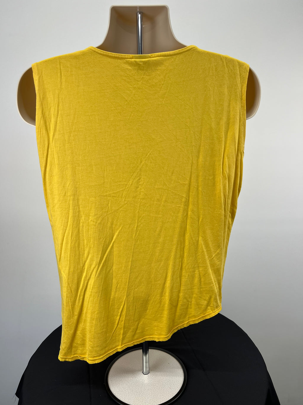 Back view of Puma x Hussein Chalayan bright yellow top showing asymmetrical hem on mannequin