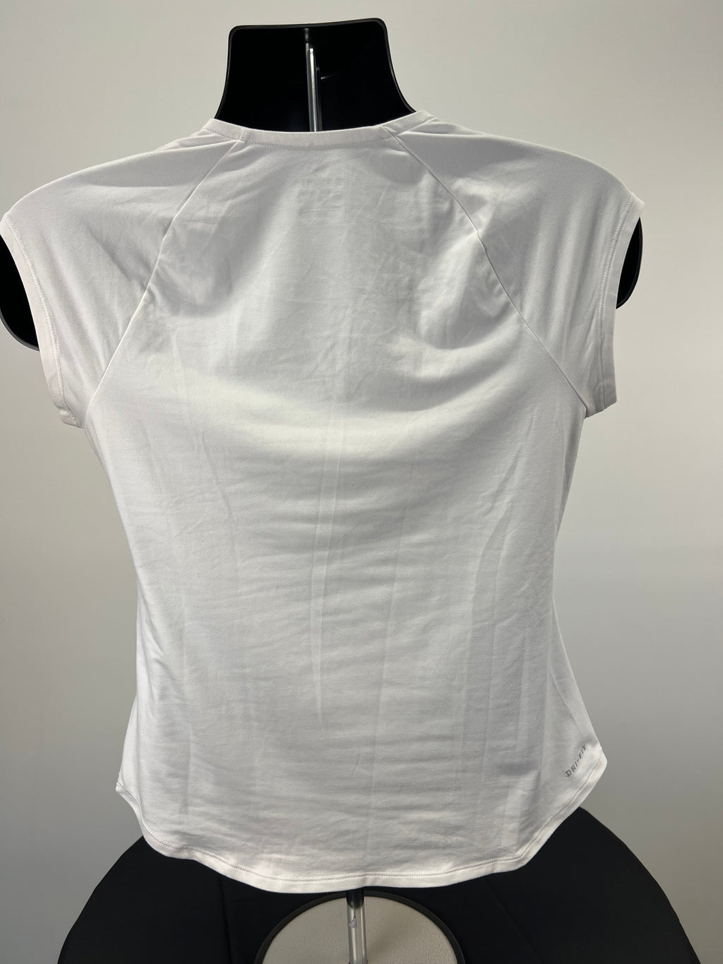 Back view of Nike Dri-Fit white V-neck T-shirt showing smooth fabric and raglan sleeves