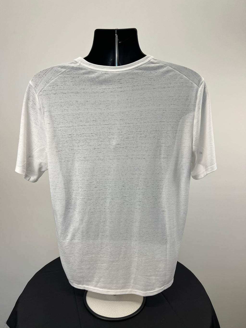 Back view of white Nike running t-shirt on black mannequin displaying simple design