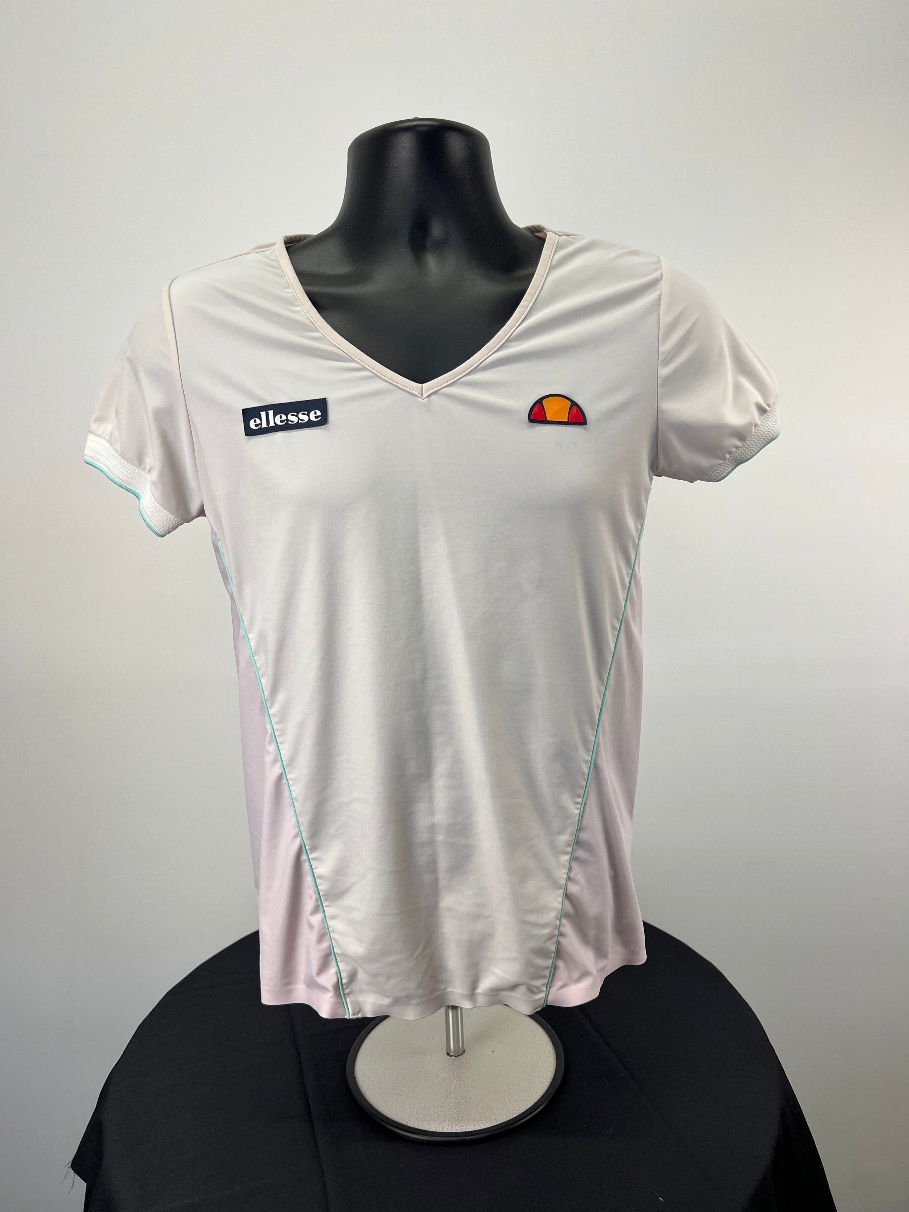 Front view of Ellesse women's short sleeve V-neck t-shirt in off-white with blush side panels and logo patches