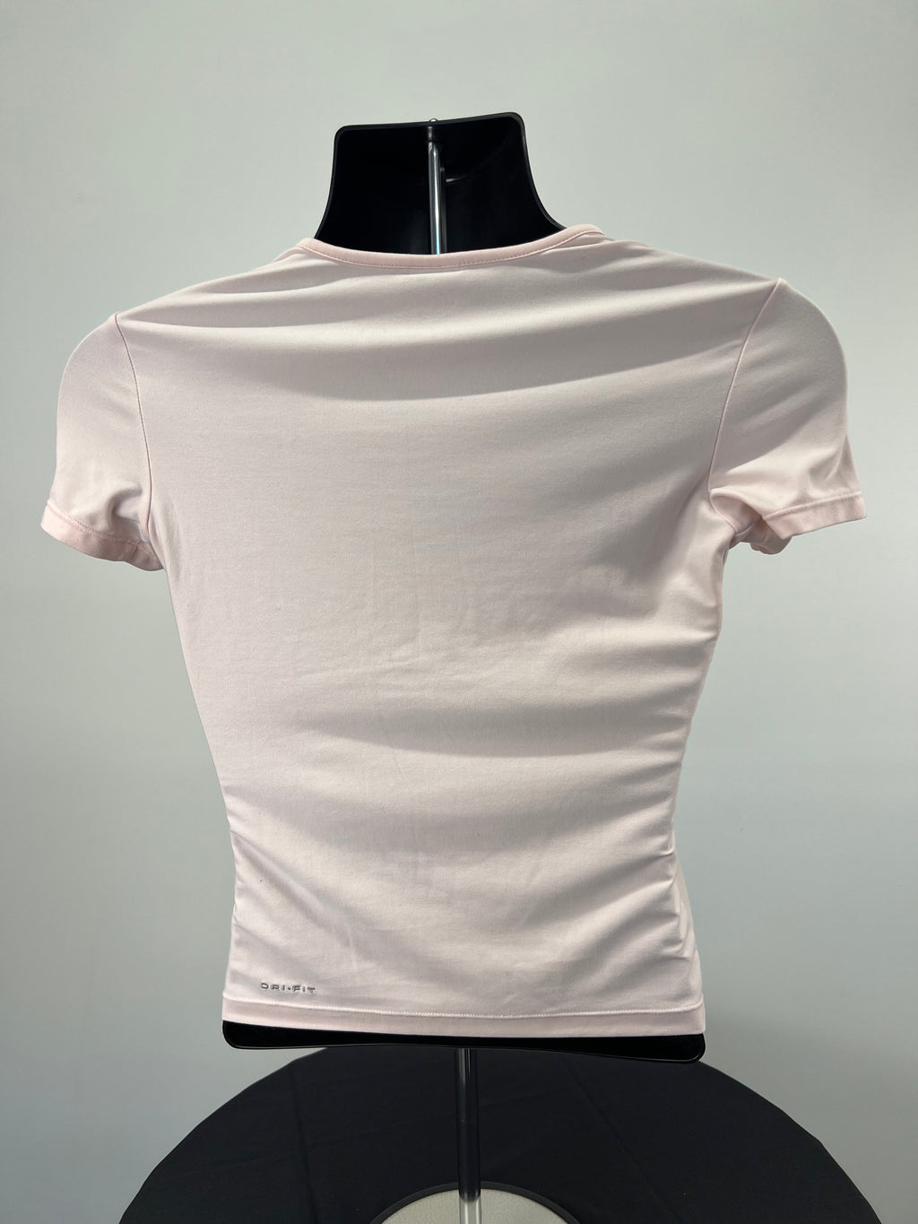 Back view of Nike light pink round neck t-shirt showing Dri-FIT logo