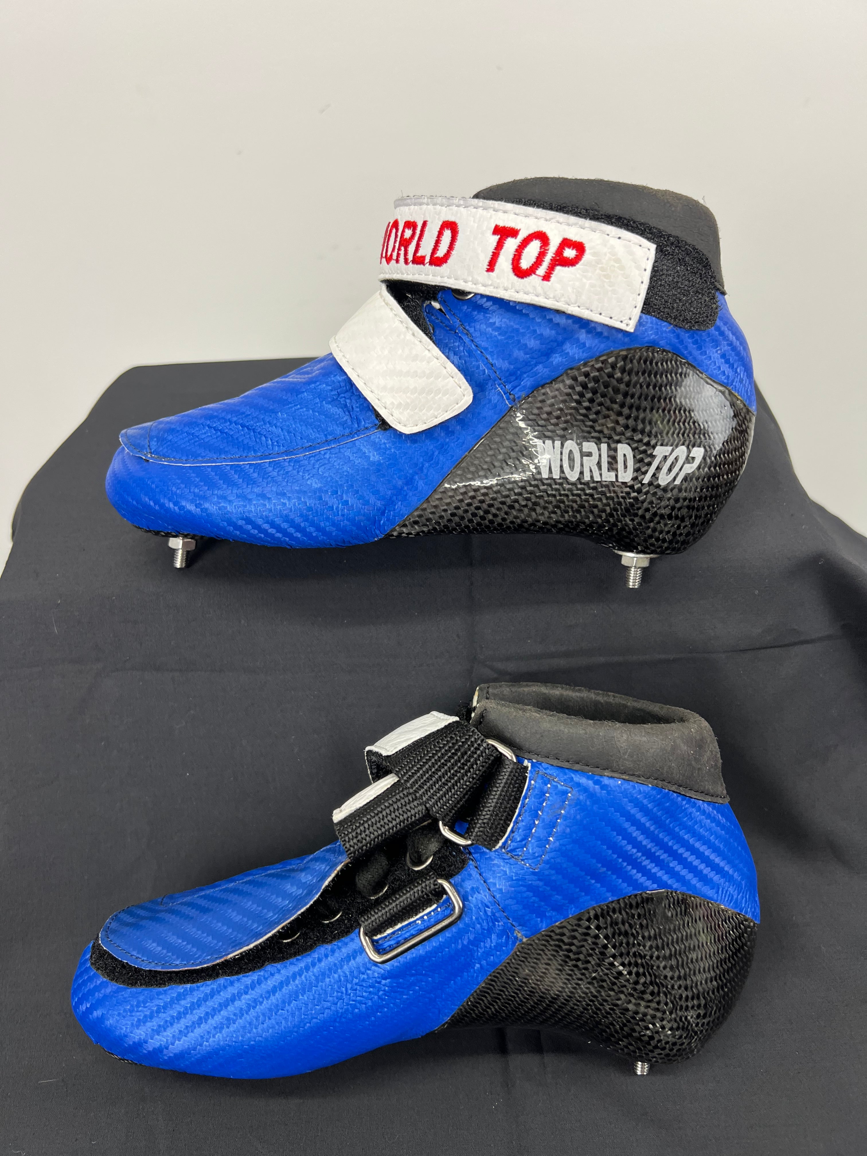 Opposite side view of blue World Top short track skate boot showing laces and ankle strap