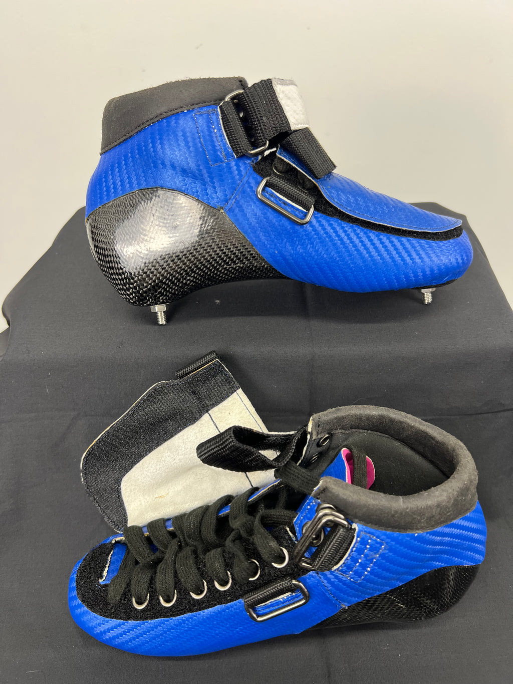 Top-down view of blue World Top short track skate boot showing laces, Velcro strap, and padded ankle collar