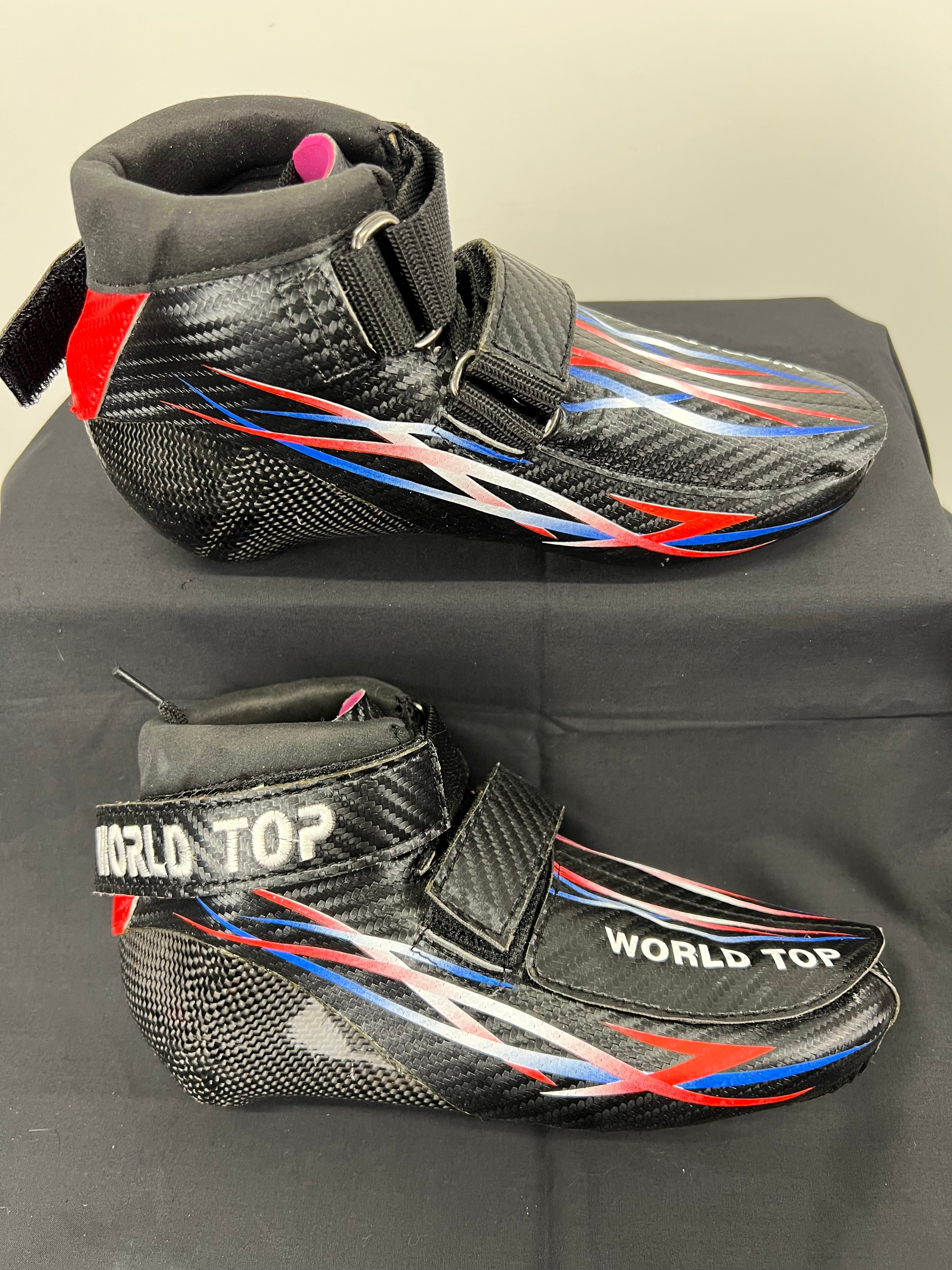 World Top size 37 short track speed skating boot in black carbon fibre with red, white and blue design detail, side view
