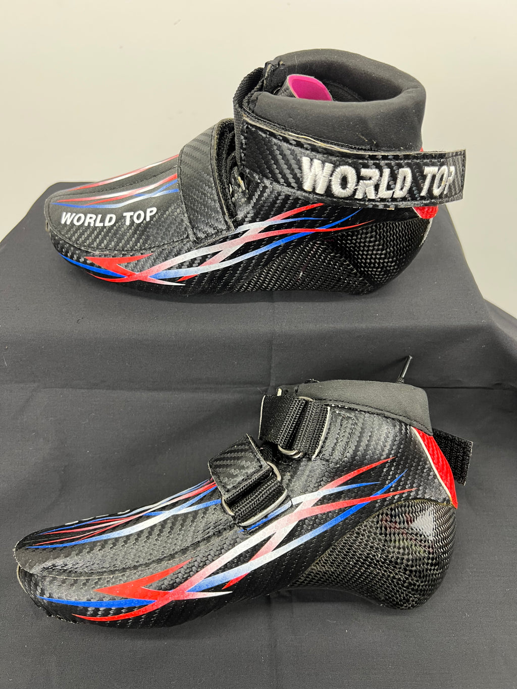 World Top short track speed skating boot in carbon fibre showing profile and ankle strap