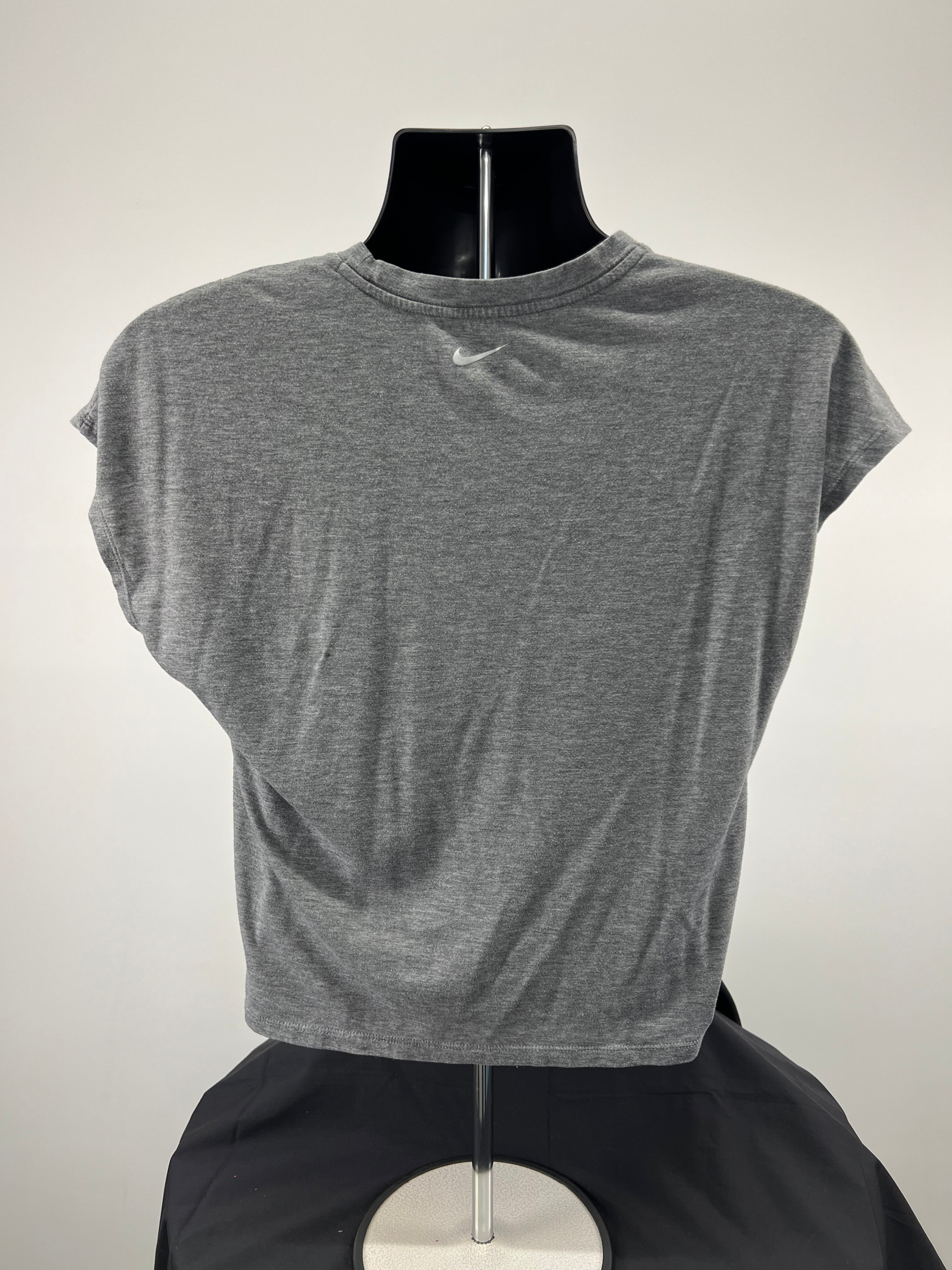Back view of grey Nike t-shirt showing plain design with small Nike swoosh logo near neck