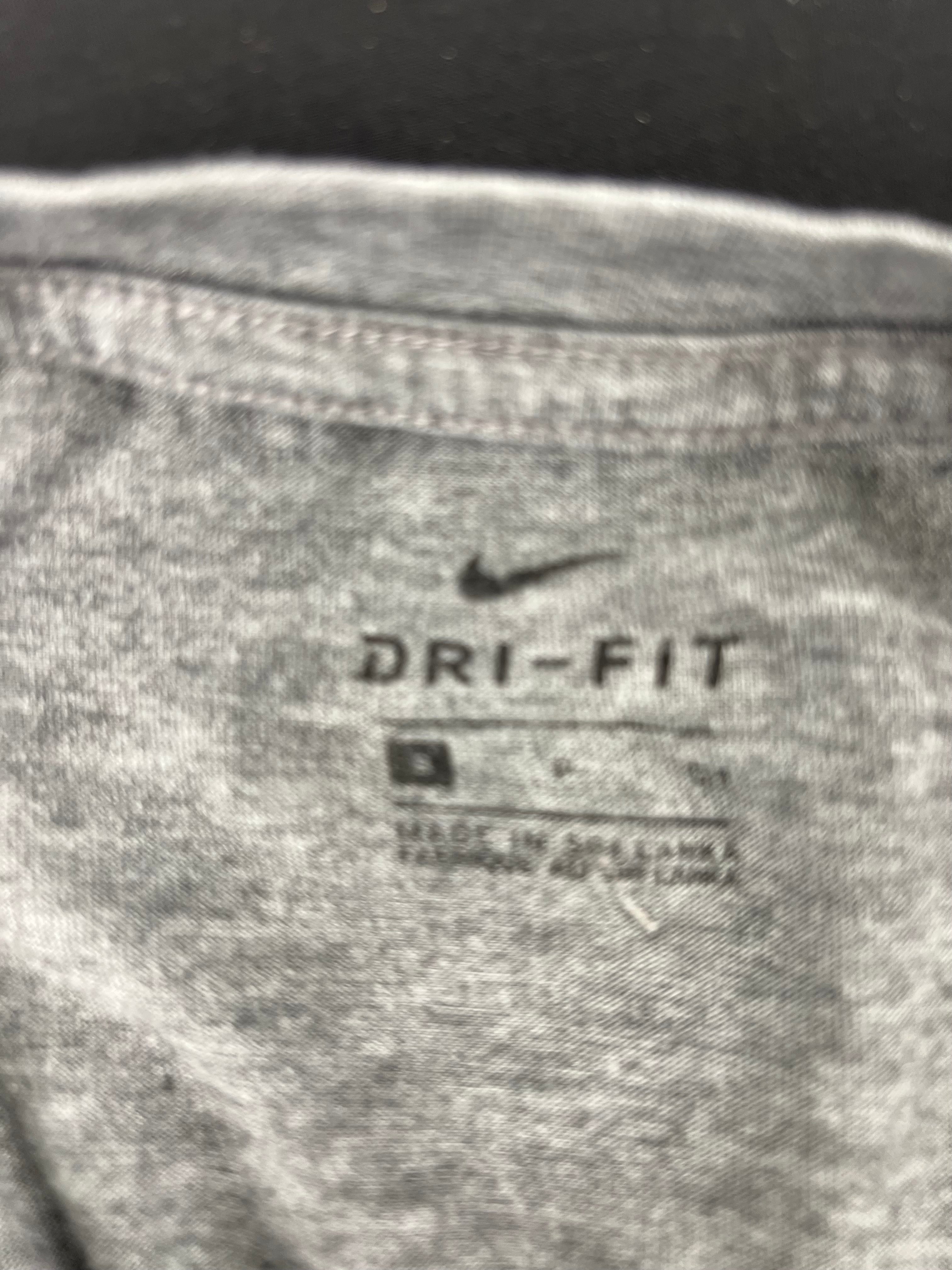 Close-up of inside neck tag showing Nike Dri-FIT branding and size information