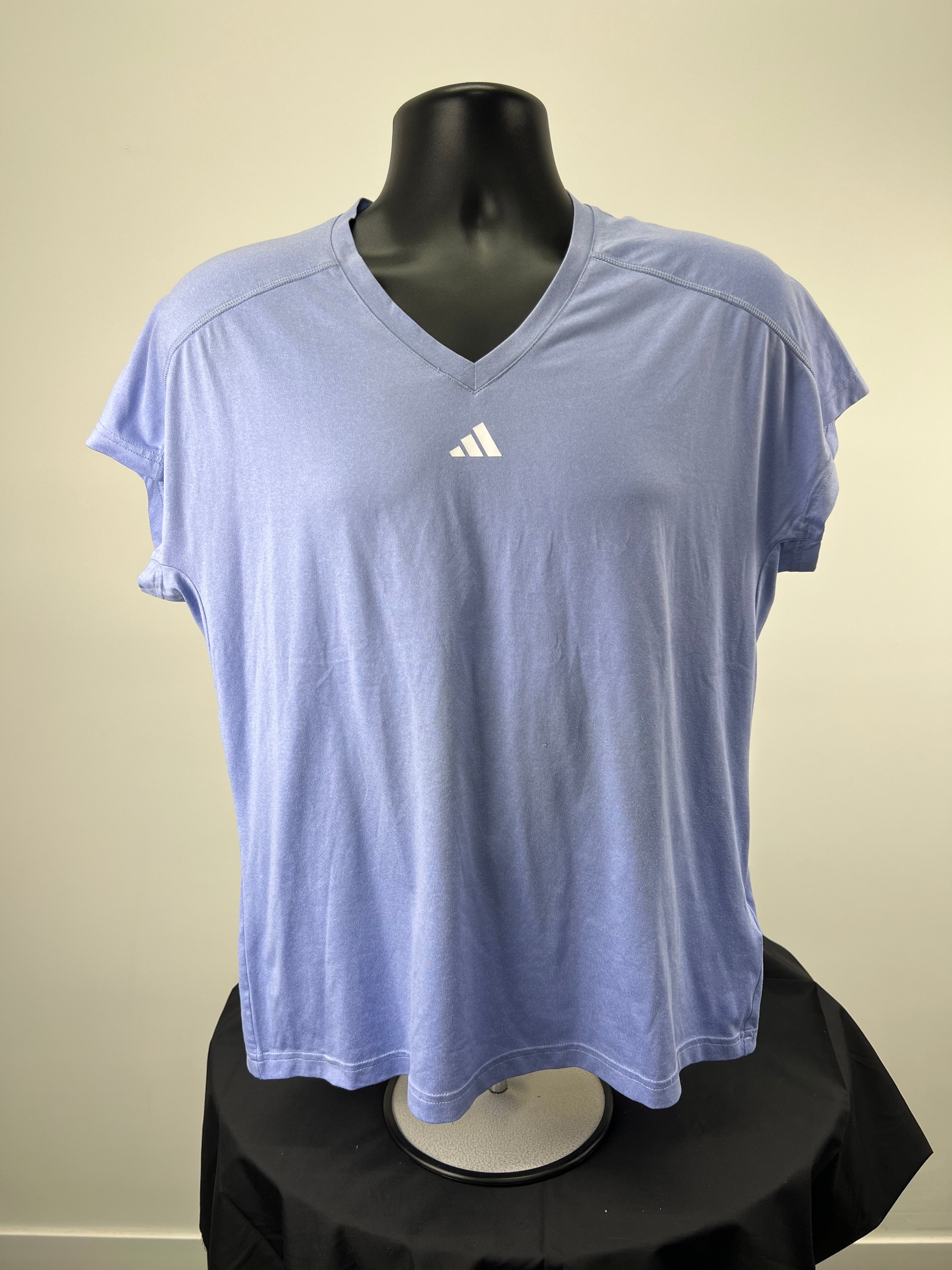 Front view of soft blue Adidas V-neck t-shirt on a mannequin