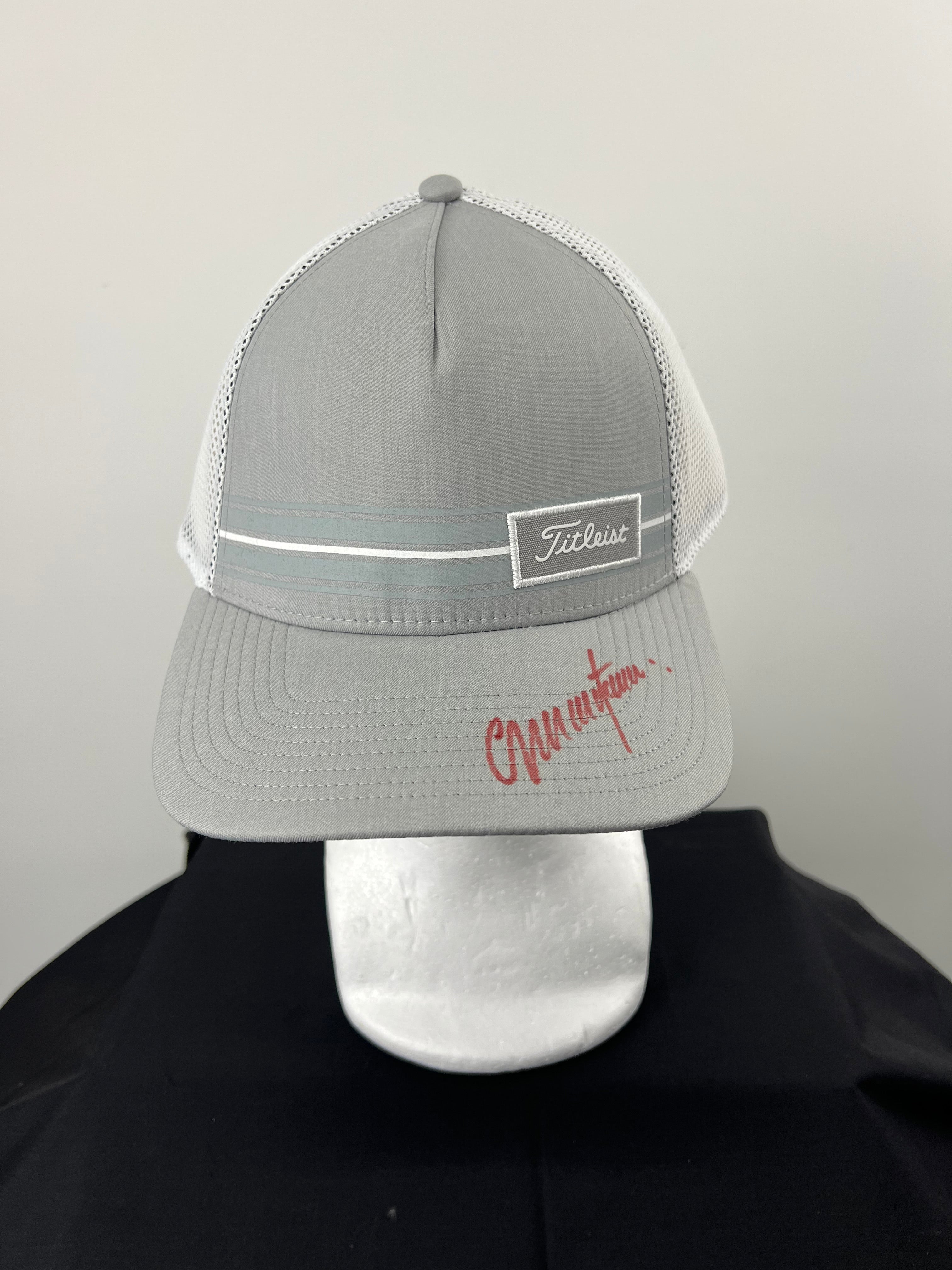 Front view of grey Titleist cap signed by Colin Montgomerie on the brim in red ink