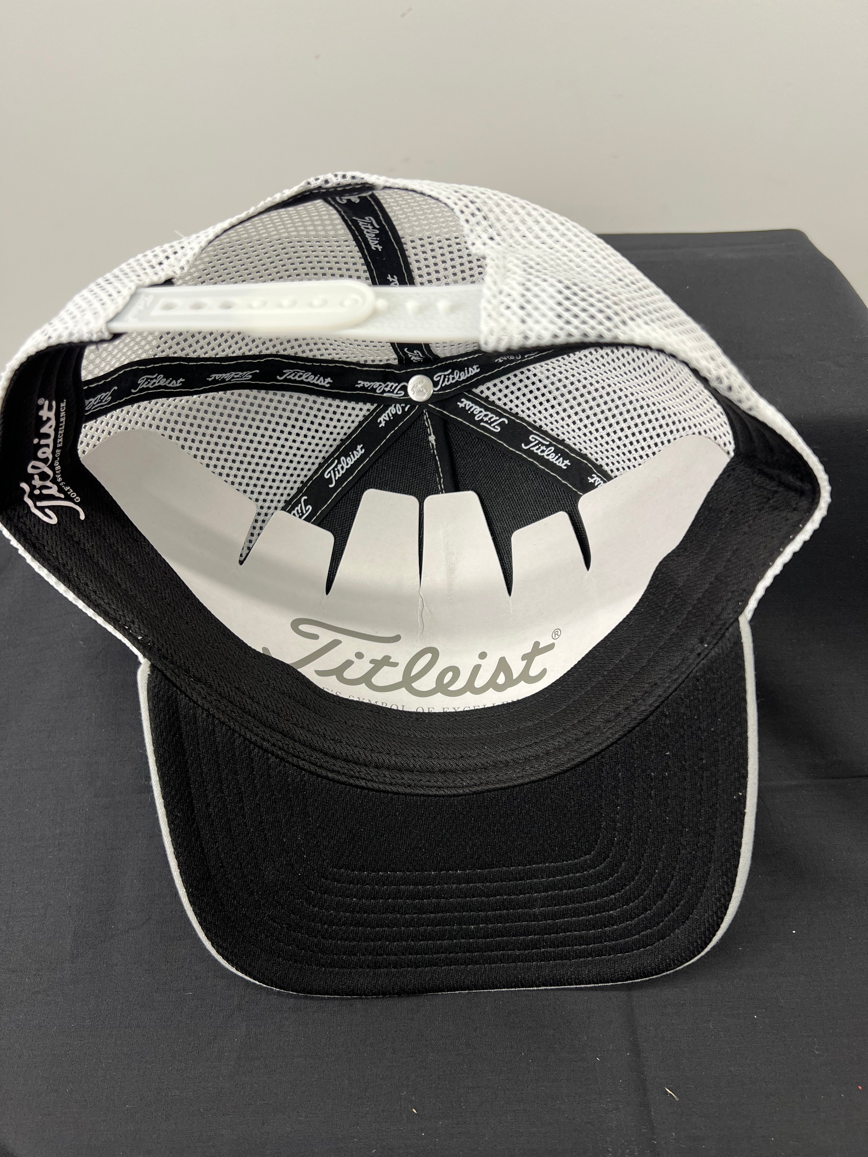 Inside view of Titleist cap showing black inner sweatband and white interior support bands