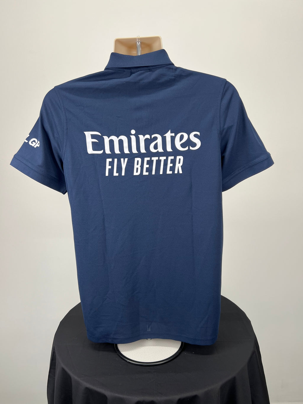 Back view of Men’s Emirates GBR x Henri Lloyd 2025 navy blue polo featuring large Emirates Fly Better logo