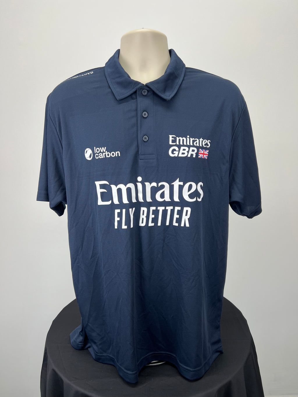 Front view of men's navy Emirates GBR x Henri Lloyd polo shirt with logos and button collar