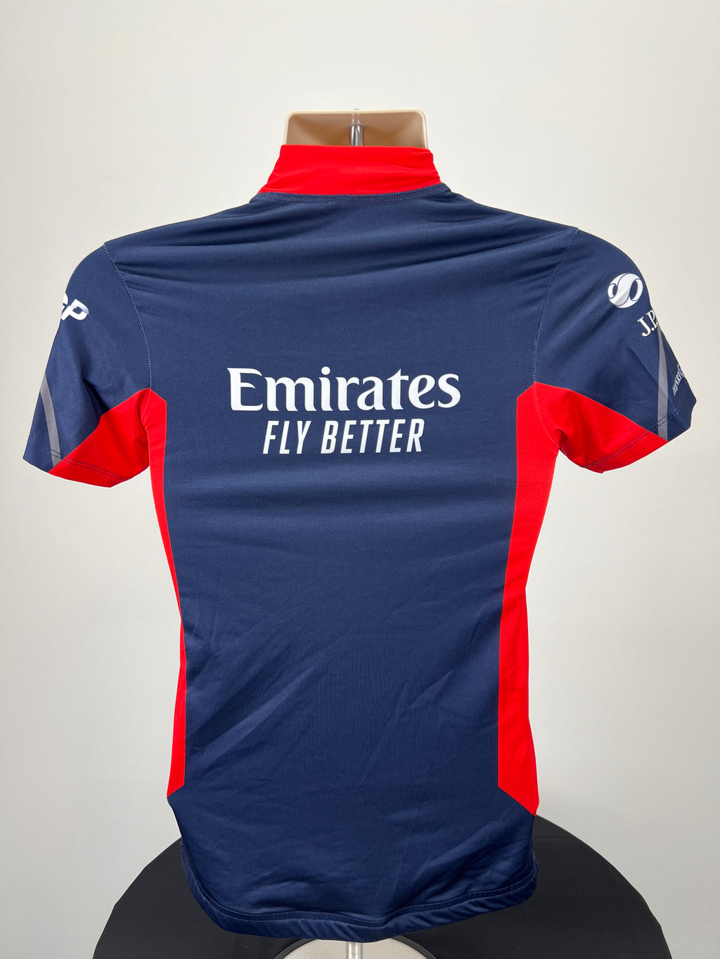 Back view of Emirates Team GBR rash vest showing logo and design in navy blue and red panels