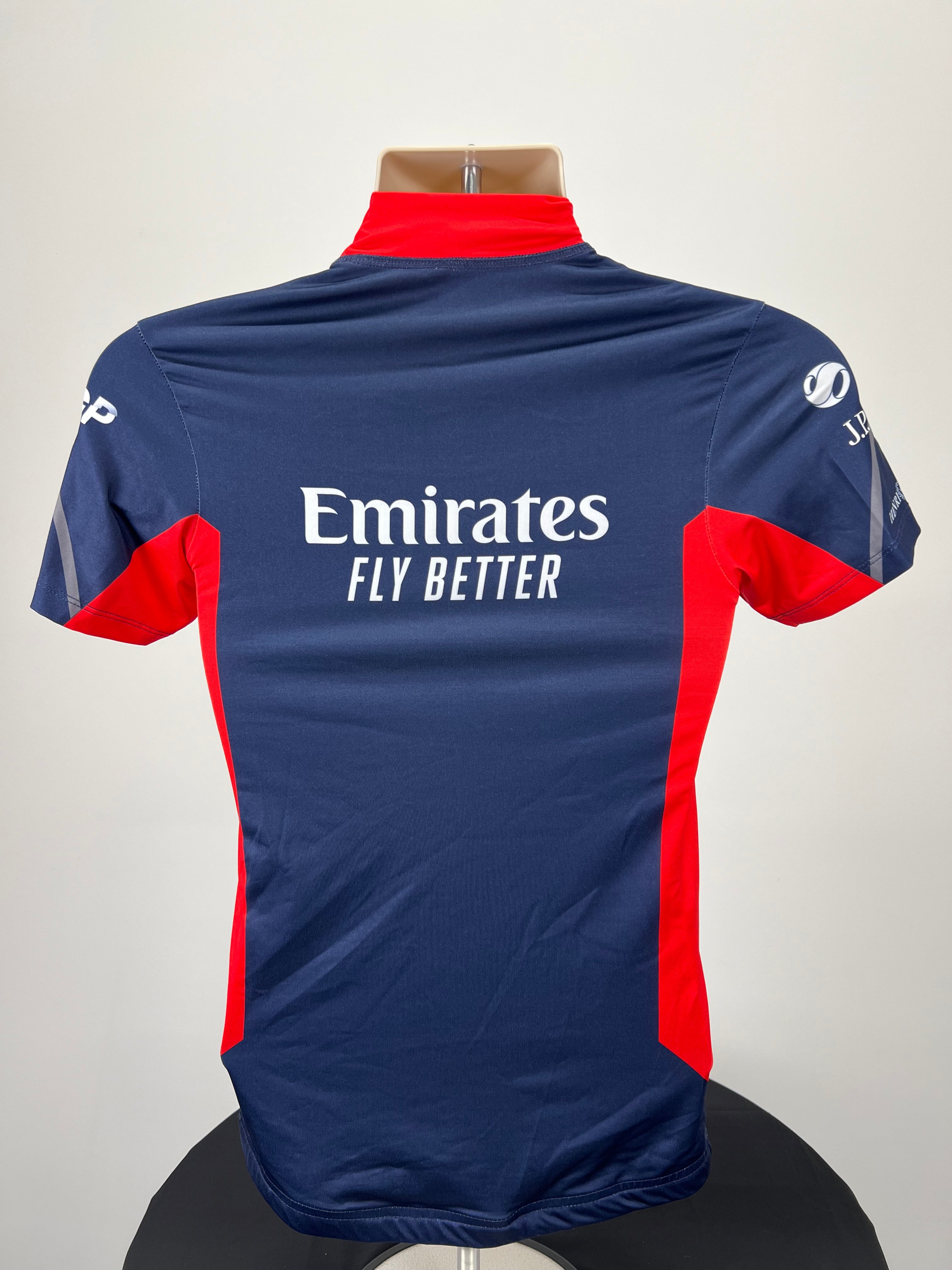 Back view of Emirates Team GBR rash vest showing logo and design in navy blue and red panels