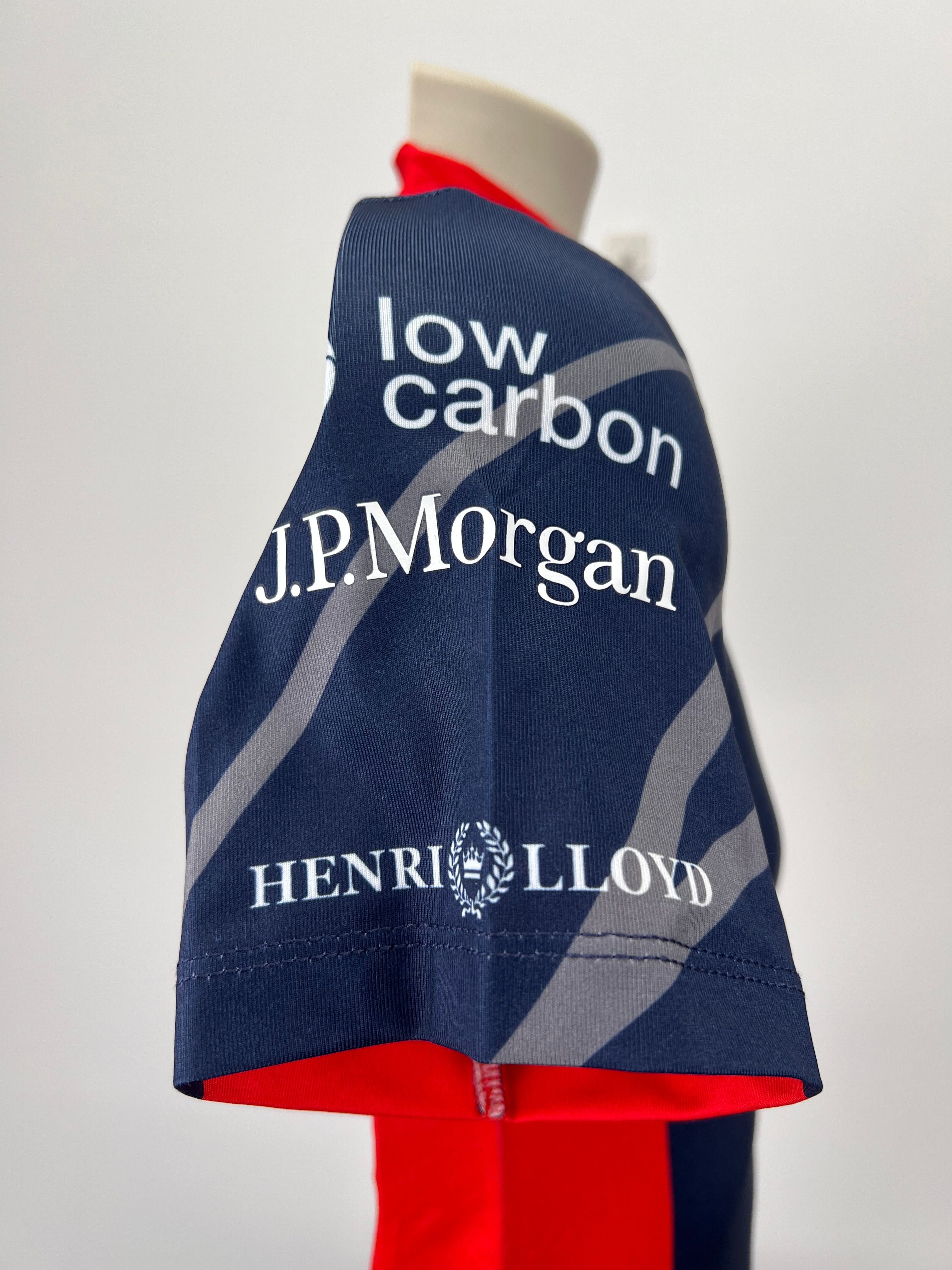 Close-up of sleeve with J.P. Morgan and Henri Lloyd sponsor logos on navy blue and red rash vest
