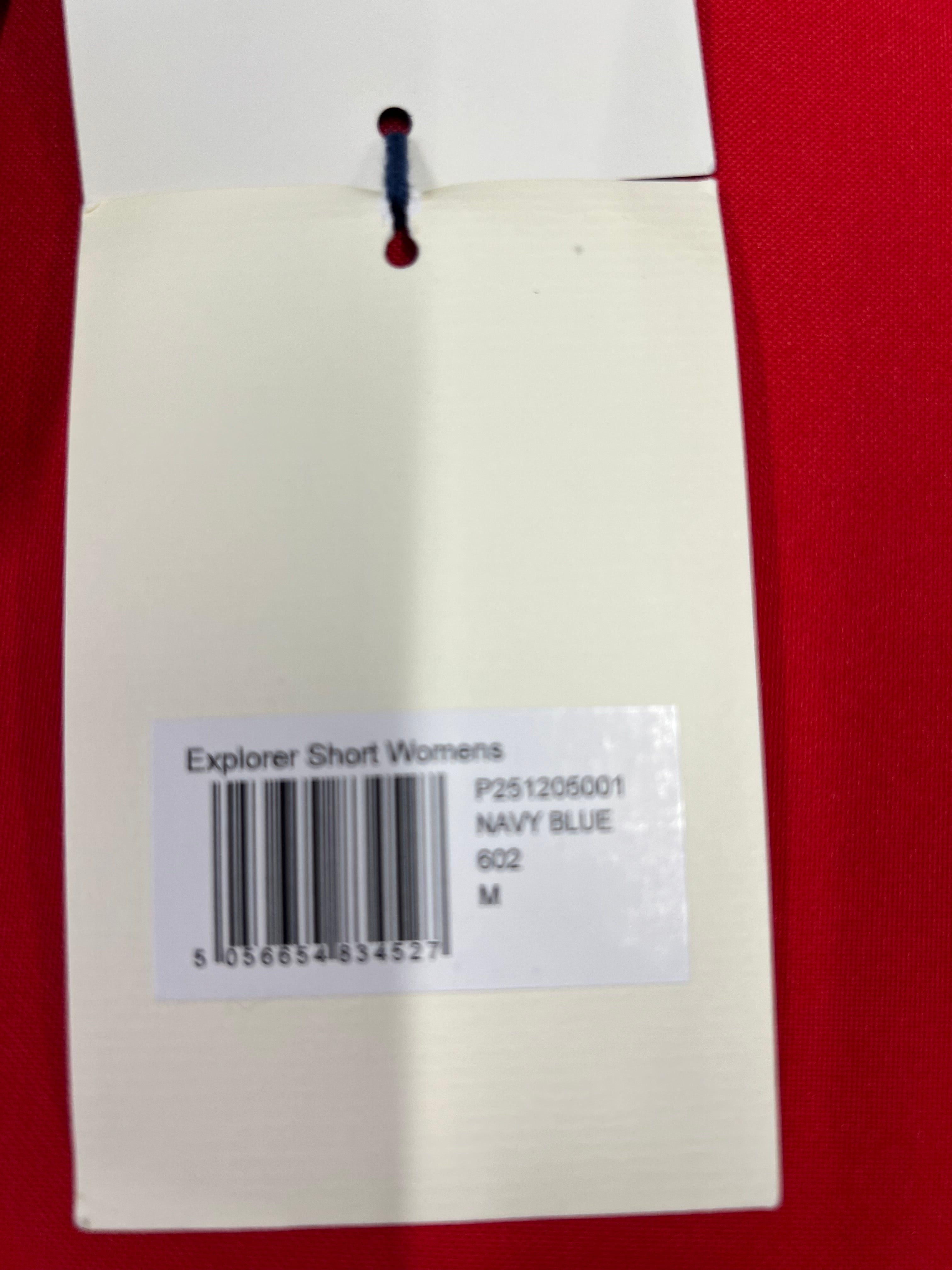 Product tag indicating size M, colour navy blue, and product name Explorer Shorts Women's