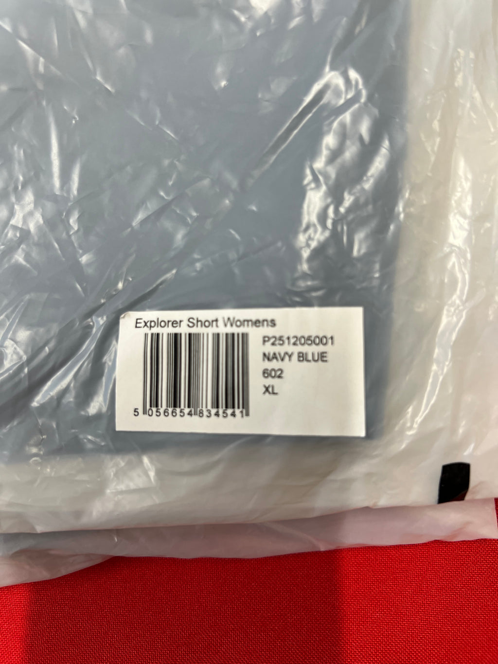 Product label on packaging showing 'Explorer Short Womens Navy Blue XL' with barcode