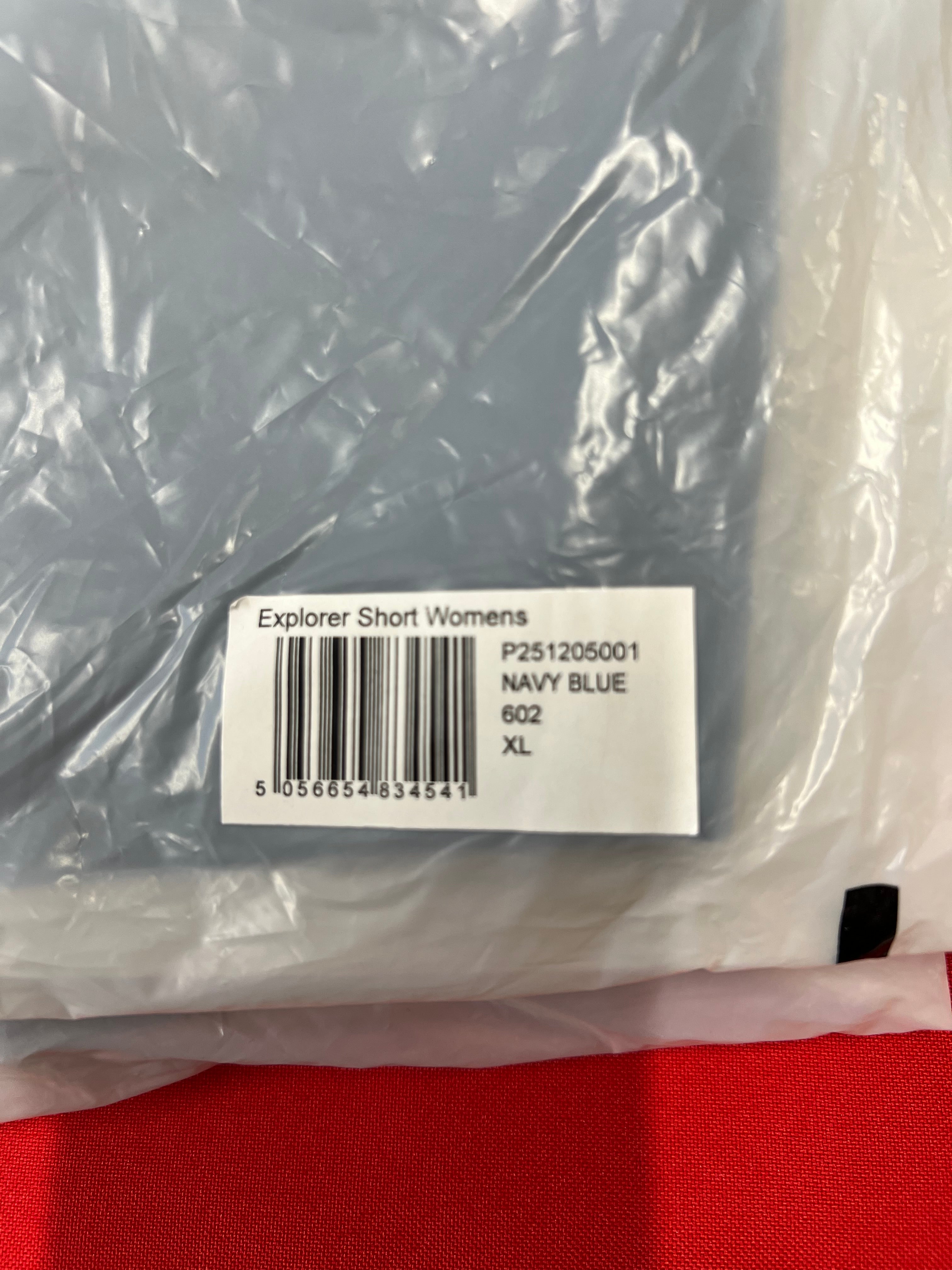 Product label on packaging showing 'Explorer Short Womens Navy Blue XL' with barcode