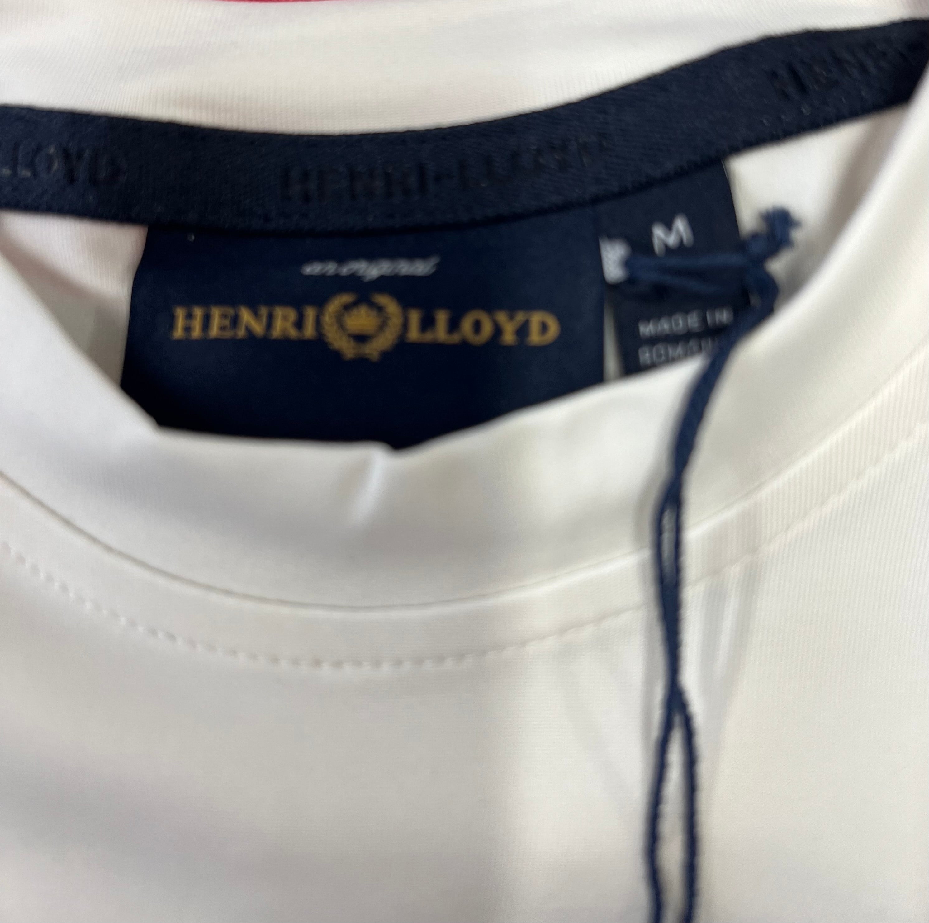 Close-up of Henri Lloyd brand label inside the white long sleeve tee collar