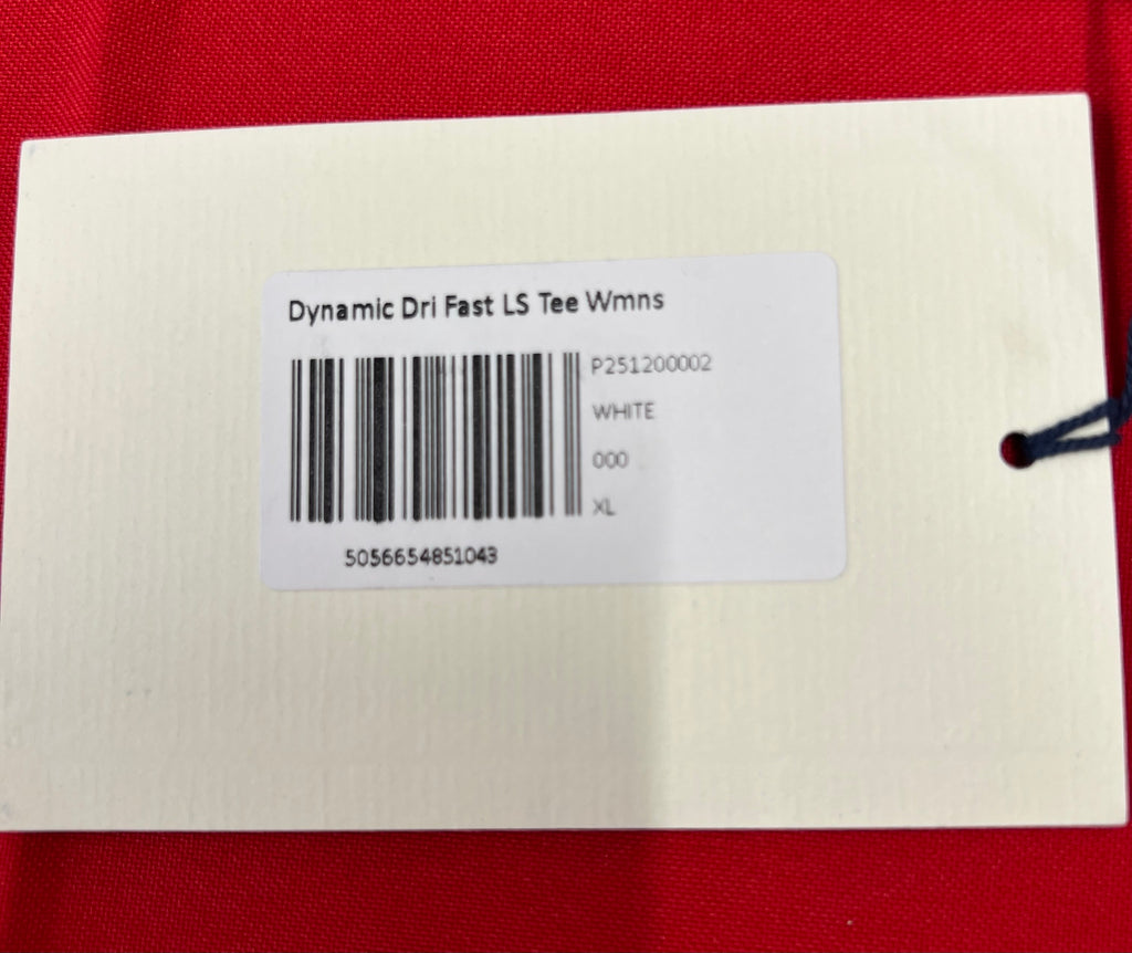 Close-up of white product label tag showing Dynamic Dri Fast LS Tee Womens size XL barcode